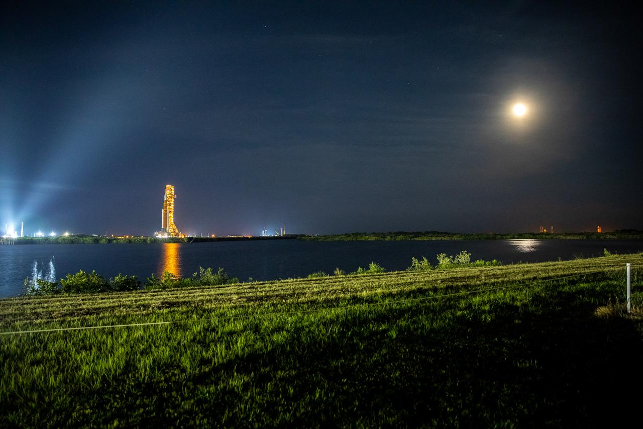 NASA’s Space Launch System (SLS) rocket, with the Orion capsule atop, slowly makes its way along the crawlerway at the agency’s Kennedy Space Center in Florida on Tuesday, Aug. 16, 2022/Wednesday, Aug. 17, 2022. Carried atop the crawler-transporter 2, NASA’s Moon rocket is venturing the 4.2 miles from the Vehicle Assembly Building to Launch Complex 39B ahead of the first flight test of the fully stacked and integrated SLS rocket and Orion spacecraft, scheduled to liftoff on Monday, Aug. 29. The first in a series of increasingly complex missions, Artemis I will provide a foundation for human deep space exploration and demonstrate our commitment and capability to extend human presence to the Moon and beyond. The primary goal of Artemis I is to thoroughly test the integrated systems before crewed missions by launching Orion atop the SLS rocket, operating the spacecraft in a deep space environment, testing Orion’s heat shield, and recovering the crew module after reentry, descent, and splashdown. In later missions, NASA will land the first woman and the first person of color on the surface of the Moon, paving the way for a long-term lunar presence and serving as a steppingstone on the way to Mars.