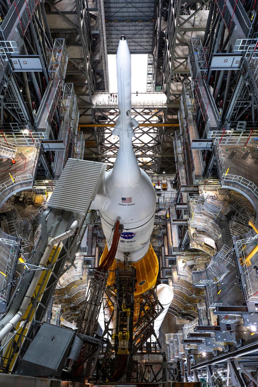 NASA’s Space Launch System and Orion spacecraft atop the mobile launcher are in view in High Bay 3 of the Vehicle Assembly Building (VAB) at the agency’s Kennedy Space Center in Florida on Tuesday, Aug. 16, 2022. All of the work platforms have been retracted in preparation for rollout to Launch Complex 39B ahead of launch of Artemis I. The crawler-transporter, driven by engineers, is under the Artemis I stack atop the mobile launcher and will carry it 4.2 miles via the crawlerway that connects the VAB to the launch pad. The agency’s Artemis I flight test is scheduled to liftoff on Monday, Aug. 29. The first in a series of increasingly complex missions, Artemis I will provide a foundation for human deep space exploration and demonstrate our commitment and capability to extend human presence to the Moon and beyond. The primary goal of Artemis I is to thoroughly test the integrated systems before crewed missions by launching Orion atop the SLS rocket, operating the spacecraft in a deep space environment, testing Orion’s heat shield, and recovering the crew module after reentry, descent, and splashdown.