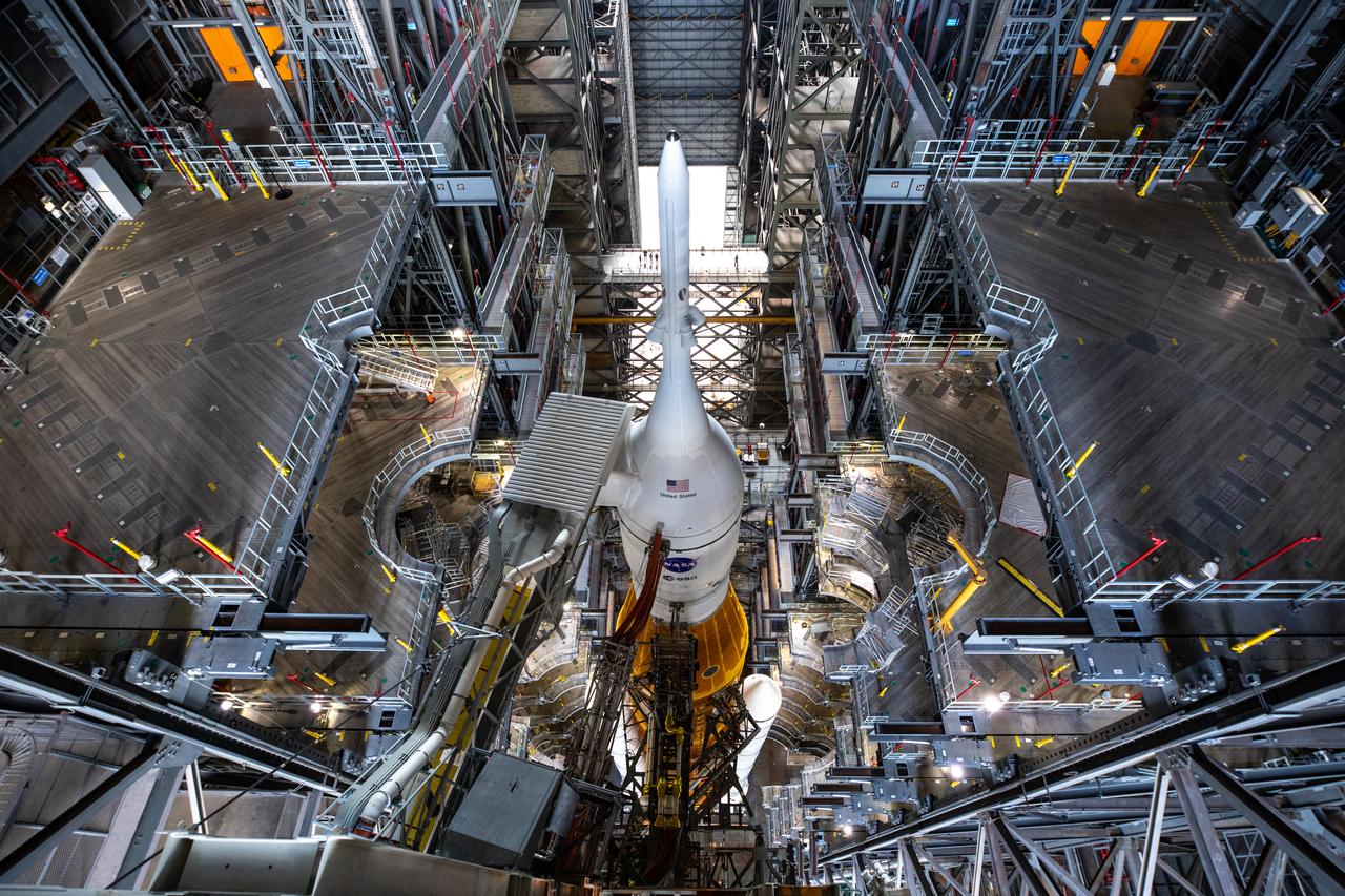NASA’s Space Launch System and Orion spacecraft atop the mobile launcher are in view in High Bay 3 of the Vehicle Assembly Building (VAB) at the agency’s Kennedy Space Center in Florida on Tuesday, Aug. 16, 2022. All of the work platforms have been retracted in preparation for rollout to Launch Complex 39B ahead of launch of Artemis I. The crawler-transporter, driven by engineers, is under the Artemis I stack atop the mobile launcher and will carry it 4.2 miles via the crawlerway that connects the VAB to the launch pad. The agency’s Artemis I flight test is scheduled to liftoff on Monday, Aug. 29. The first in a series of increasingly complex missions, Artemis I will provide a foundation for human deep space exploration and demonstrate our commitment and capability to extend human presence to the Moon and beyond. The primary goal of Artemis I is to thoroughly test the integrated systems before crewed missions by launching Orion atop the SLS rocket, operating the spacecraft in a deep space environment, testing Orion’s heat shield, and recovering the crew module after reentry, descent, and splashdown.
