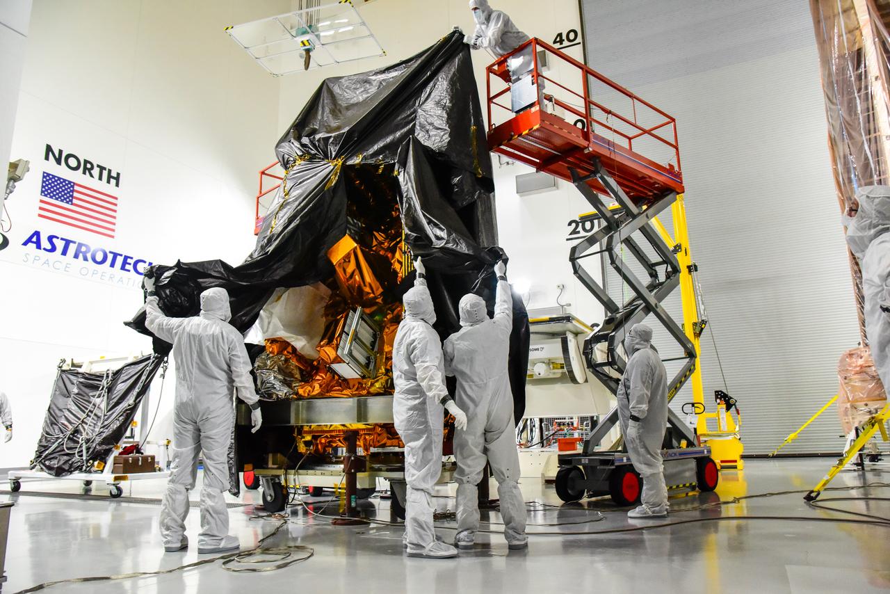 Technicians remove the protective covering from NASA and the National Oceanic and Atmospheric Administration’s (NOAA) Joint Polar Satellite System-2 (JPSS-2) satellite inside the Astrotech Space Operations facility at Vandenberg Space Force Base in California on Aug. 22, 2022. JPSS-2 is the third satellite in the Joint Polar Satellite System series. It is scheduled to lift off from VSFB on Nov. 1 from Space Launch Complex-3. JPSS-2, which will be renamed NOAA-21 after reaching orbit, will join a constellation of JPSS satellites that orbit from the North to the South pole, circling Earth 14 times a day and providing a full view of the entire globe twice daily. The NOAA/NASA Suomi National Polar-orbiting Partnership (Suomi NPP) satellite, and NOAA-20, previously known as JPSS-1, are both already in orbit. Each satellite carries at least four advanced instruments to measure weather and climate conditions on Earth. A secondary payload on the mission is the Low-Earth Orbit Flight Test of an Inflatable Decelerator (LOFTID), and is dedicated to the memory of Bernard Kutter. LOFTID will demonstrate inflatable heat shield technology that could enable a variety of proposed NASA missions to destinations such as Mars, Venus, and Titan, as well as returning heavier payloads from low-Earth orbit.