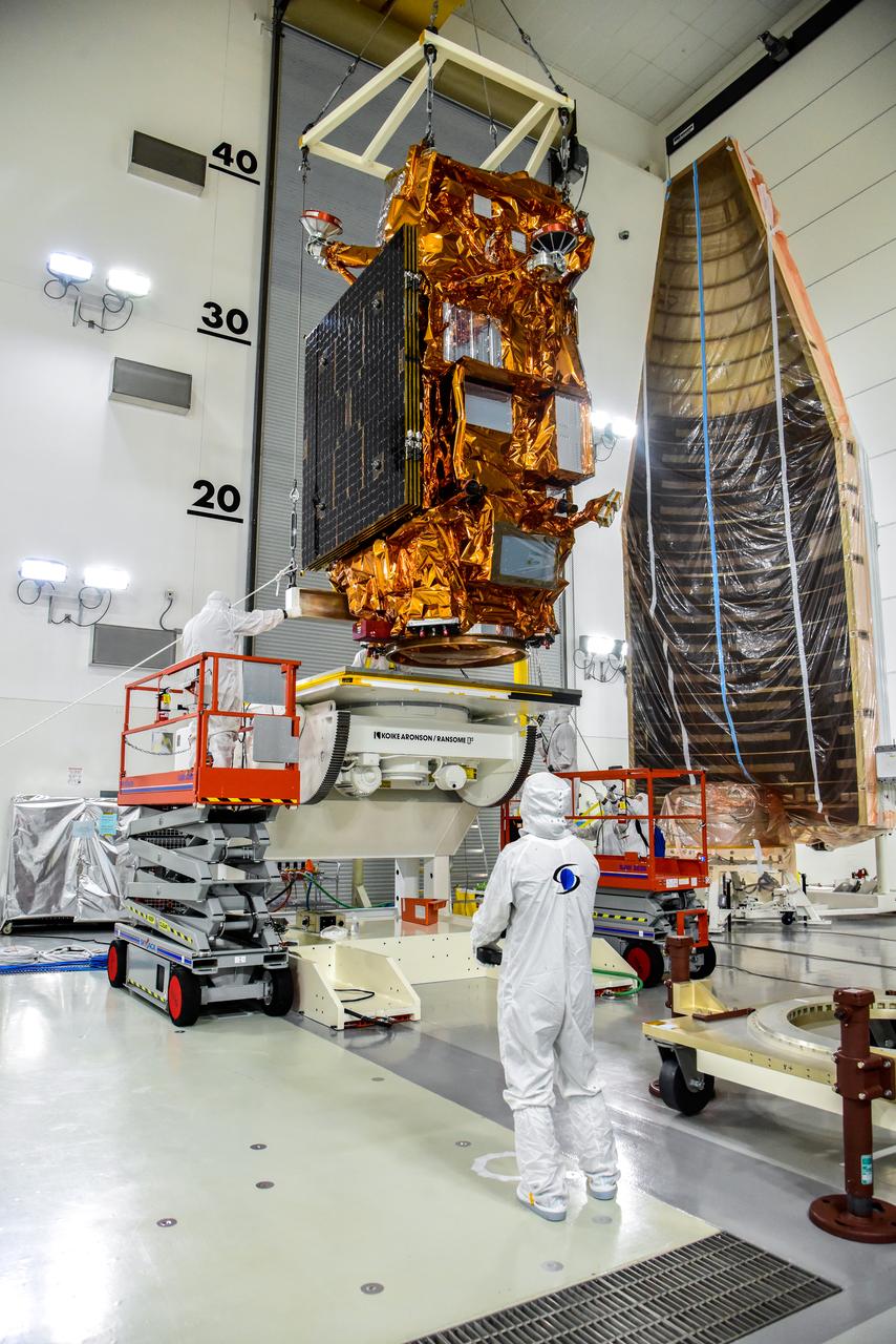 A crane is used to transfer NASA and the National Oceanic and Atmospheric Administration’s (NOAA) Joint Polar Satellite System-2 (JPSS-2) satellite to an Aronson Table for processing inside the Astrotech Space Operations facility at Vandenberg Space Force Base in California on Aug. 22, 2022. JPSS-2 is the third satellite in the Joint Polar Satellite System series. It is scheduled to lift off from VSFB on Nov. 1 from Space Launch Complex-3. JPSS-2, which will be renamed NOAA-21 after reaching orbit, will join a constellation of JPSS satellites that orbit from the North to the South pole, circling Earth 14 times a day and providing a full view of the entire globe twice daily. The NOAA/NASA Suomi National Polar-orbiting Partnership (Suomi NPP) satellite, and NOAA-20, previously known as JPSS-1, are both already in orbit. Each satellite carries at least four advanced instruments to measure weather and climate conditions on Earth. A secondary payload on the mission is the Low-Earth Orbit Flight Test of an Inflatable Decelerator (LOFTID), and is dedicated to the memory of Bernard Kutter. LOFTID will demonstrate inflatable heat shield technology that could enable a variety of proposed NASA missions to destinations such as Mars, Venus, and Titan, as well as returning heavier payloads from low-Earth orbit. 