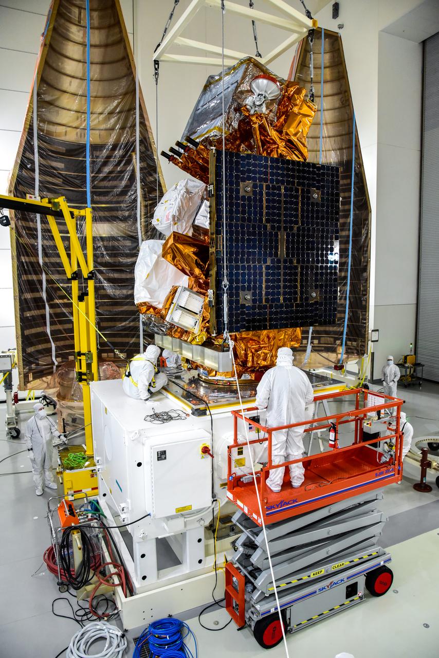 Technicians secure NASA and the National Oceanic and Atmospheric Administration’s (NOAA) Joint Polar Satellite System-2 (JPSS-2) satellite onto an Aronson Table inside the Astrotech Space Operations facility at Vandenberg Space Force Base in California on Aug. 22, 2022. In the background are the United Launch Alliance Atlas V payload fairings that will encase the satellite and protect it during launch. JPSS-2 is the third satellite in the Joint Polar Satellite System series. It is scheduled to lift off from VSFB on Nov. 1 from Space Launch Complex-3. JPSS-2, which will be renamed NOAA-21 after reaching orbit, will join a constellation of JPSS satellites that orbit from the North to the South pole, circling Earth 14 times a day and providing a full view of the entire globe twice daily. The NOAA/NASA Suomi National Polar-orbiting Partnership (Suomi NPP) satellite, and NOAA-20, previously known as JPSS-1, are both already in orbit. Each satellite carries at least four advanced instruments to measure weather and climate conditions on Earth. A secondary payload on the mission is the Low-Earth Orbit Flight Test of an Inflatable Decelerator (LOFTID), and is dedicated to the memory of Bernard Kutter. LOFTID will demonstrate inflatable heat shield technology that could enable a variety of proposed NASA missions to destinations such as Mars, Venus, and Titan, as well as returning heavier payloads from low-Earth orbit.