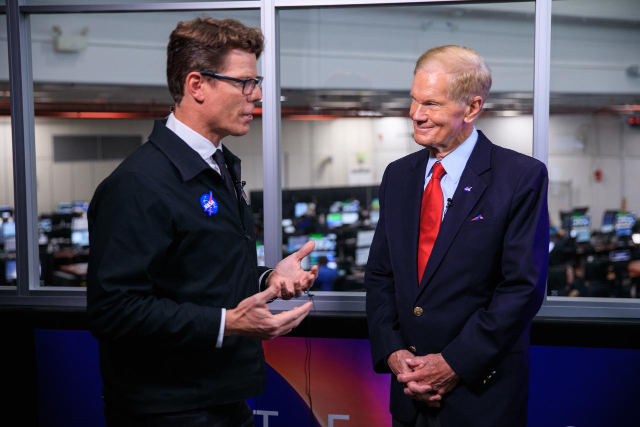 NASA commentator Derrol Nail, at left, talks with NASA Administrator Bill Nelson during the Artemis I launch countdown inside Firing Room 1 of the Rocco A. Petrone Launch Control Center at NASA’s Kennedy Space Center in Florida on  Aug. 29, 2022. Launch of the agency’s Space Launch System and Orion spacecraft was waved off due to an issue during tanking. Launch is now no earlier than Sept. 3, at 2:17 p.m. EDT from Kennedy’s Launch Complex 39B. The first in a series of increasingly complex missions, Artemis I will provide a foundation for human deep space exploration and demonstrate our commitment and capability to extend human presence to the Moon and beyond. The primary goal of Artemis I is to thoroughly test the integrated systems before crewed missions by operating the spacecraft in a deep space environment, testing Orion’s heat shield, and recovering the crew module after reentry, descent, and splashdown. 