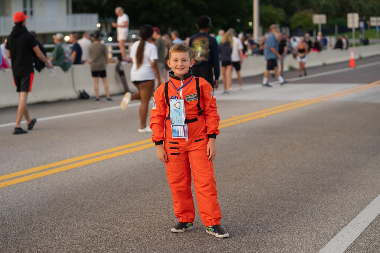 A young child dressed in an astronaut spacesuit is one of the spectators gathering on the Max Brewer Bridge in Titusville, Florida, to witness NASA’s Artemis I launch on Aug. 29, 2022. The launch was waved off for the day at the agency’s Kennedy Space Center. The first in a series of increasingly complex missions, Artemis I will provide a foundation for human deep space exploration and demonstrate our commitment and capability to extend human presence to the Moon and beyond. The primary goal of Artemis I is to thoroughly test the integrated systems before crewed missions by operating the spacecraft in a deep space environment, testing Orion’s heat shield, and recovering the crew module after reentry, descent, and splashdown. 