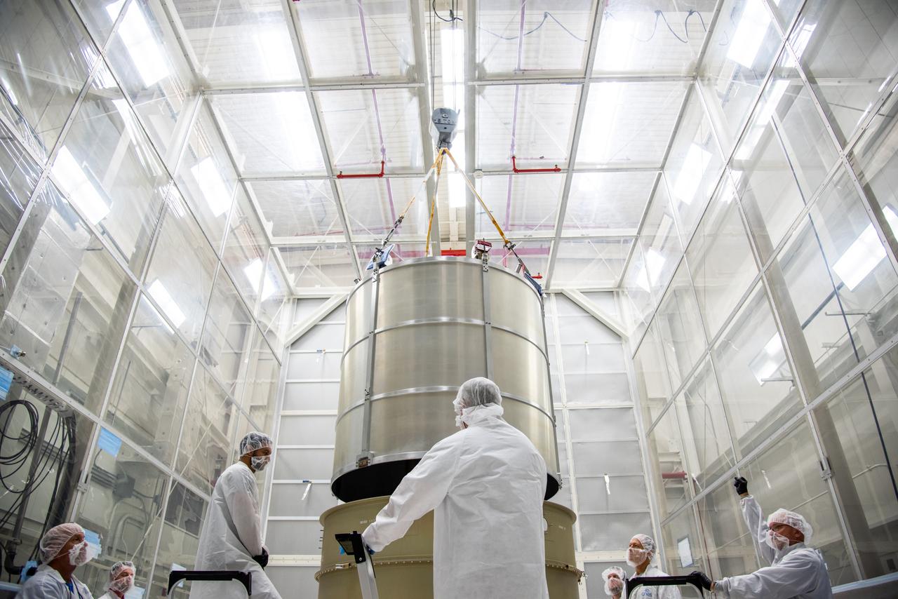 Technicians lower the payload adapter separation systems canister for the Low-Earth Orbit Flight Test of an Inflatable Decelerator (LOFTID) into the payload adapter canister as part of launch preparations inside Building 836 at Vandenberg Space Force Base (VSFB) in California on Sept. 1, 2022. LOFTID is the secondary payload on NASA and the National Oceanic and Atmospheric Administration’s (NOAA) Joint Polar Satellite System-2 (JPSS-2) satellite mission. JPSS-2 is the third satellite in the Joint Polar Satellite System series. It is scheduled to lift off from VSFB on Nov. 1 from Space Launch Complex-3. JPSS-2, which will be renamed NOAA-21 after reaching orbit, will join a constellation of JPSS satellites that orbit from the North to the South pole, circling Earth 14 times a day and providing a full view of the entire globe twice daily. LOFTID will demonstrate inflatable heat shield technology that could enable a variety of proposed NASA missions to destinations such as Mars, Venus, and Titan, as well as returning heavier payloads from low-Earth orbit. 