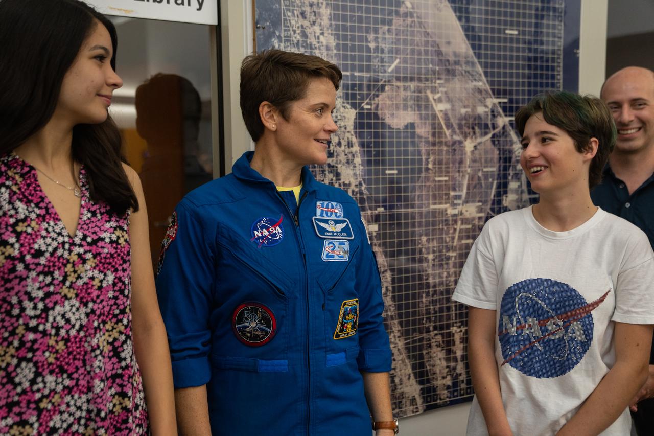 NASA astronaut Anne McClain talks with student essay winners Amanda Gutierrez, left, and Taia Saurer at the agency’s news center at Kennedy Space Center in Florida on Sept. 2, 2022. Gutierrez and Saurer won the Artemis Moon Pod Essay Contest – a nationwide event involving nearly 14,000 students – for their creative visions of a pioneering journey to the Moon. The grand prize was a trip to Kennedy to watch the launch of Artemis I. Gutierrez, 17, is an 11th-grader from Lincoln, Nebraska, while Saurer, 14, is an eighth-grader from Laguna Beach, California.