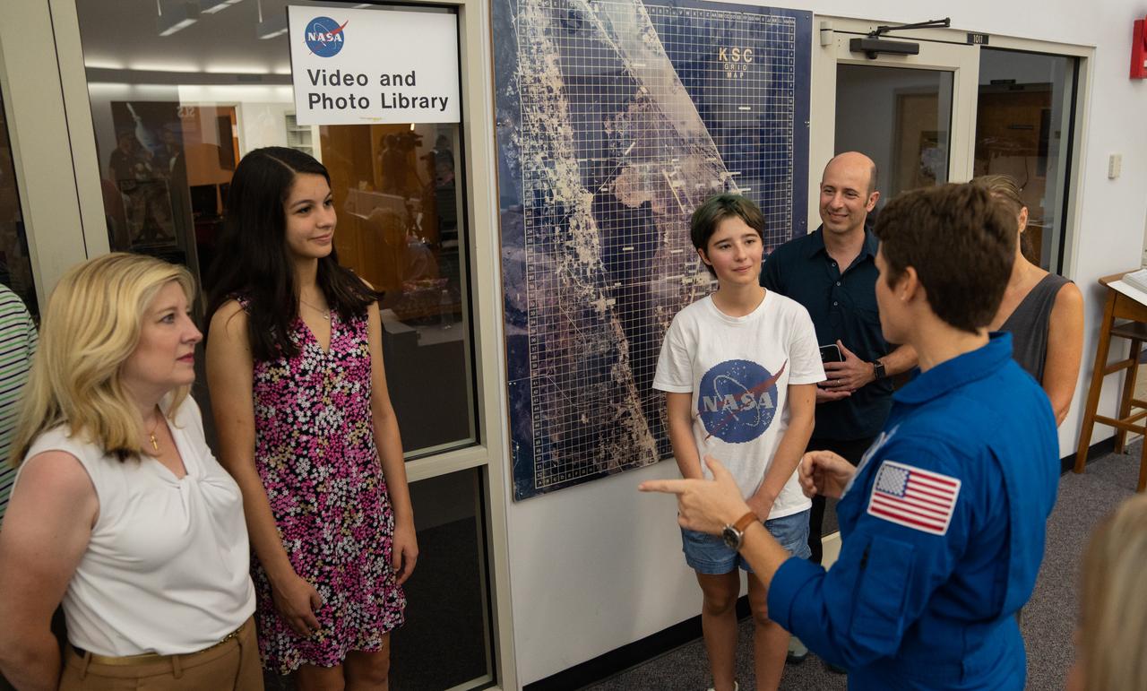 NASA astronaut Anne McClain talks with student essay winners Amanda Gutierrez, second from left, and Taia Saurer, white NASA shirt, at the agency’s news center at Kennedy Space Center in Florida on Sept. 2, 2022. Gutierrez and Saurer won the Artemis Moon Pod Essay Contest – a nationwide event involving nearly 14,000 students – for their creative visions of a pioneering journey to the Moon. The grand prize was a trip to Kennedy to watch the launch of Artemis I. Gutierrez, 17, is an 11th-grader from Lincoln, Nebraska, while Saurer, 14, is an eighth-grader from Laguna Beach, California.