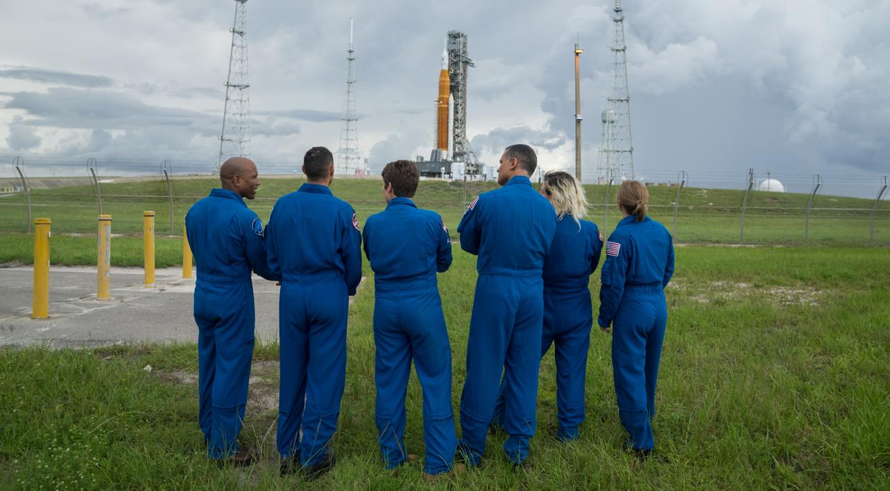 NASA astronauts and astronaut candidates view NASA’s Artemis I Space Launch System and Orion spacecraft atop the mobile launcher on the pad at Launch Complex 39B at the agency’s Kennedy Space Center in Florida on Sept. 2, 2022. The astronauts are, from left to right: Victor Glover, NASA astronaut; Marcos Berrios, NASA astronaut candidate; Anne McClain, NASA astronaut; Anil Menon and Deniz Burnham, NASA astronaut candidates; and Zena Cardman, NASA astronaut. The first in a series of increasingly complex missions, Artemis I will provide a foundation for human deep space exploration and demonstrate our commitment and capability to extend human presence to the Moon and beyond. The primary goal of Artemis I is to thoroughly test the integrated systems before crewed missions by operating the spacecraft in a deep space environment, testing Orion’s heat shield, and recovering the crew module after reentry, descent, and splashdown. In later missions, NASA will land the first woman and the first person of color on the surface of the Moon, paving the way for a long-term lunar presence and serving as a steppingstone on the way to Mars.