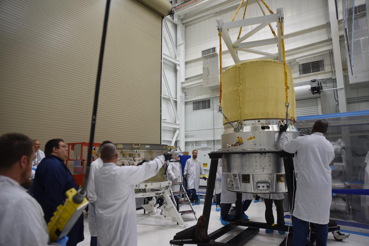 Technicians use a crane to lift the re-entry vehicle for the Low-Earth Orbit Flight Test of an Inflatable Decelerator (LOFTID) for mating to the re-entry vehicle payload adapter interface ring as part of launch preparations inside Building 836 at Vandenberg Space Force Base (VSFB) in California on Sept. 7, 2022.  LOFTID is the secondary payload on NASA and the National Oceanic and Atmospheric Administration’s (NOAA) Joint Polar Satellite System-2 (JPSS-2) satellite mission. JPSS-2 is the third satellite in the Joint Polar Satellite System series. It is scheduled to lift off from VSFB on Nov. 1 from Space Launch Complex-3. JPSS-2, which will be renamed NOAA-21 after reaching orbit, will join a constellation of JPSS satellites that orbit from the North to the South pole, circling Earth 14 times a day and providing a full view of the entire globe twice daily. The LOFTID is dedicated to the memory of Bernard Kutter. LOFTID will demonstrate inflatable heat shield technology that could enable a variety of proposed NASA missions to destinations such as Mars, Venus, and Titan, as well as returning heavier payloads from low-Earth orbit. 