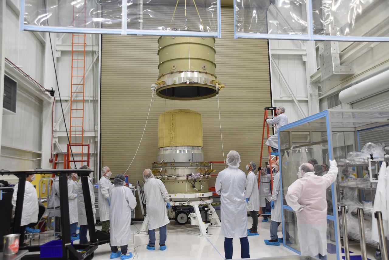 Technicians use a crane to mate the re-entry vehicle payload adapter canister for the Low-Earth Orbit Flight Test of an Inflatable Decelerator (LOFTID) with the payload adapter separation systems canister as part of launch preparations occurring inside Building 836 at Vandenberg Space Force Base (VSFB) in California on Sept. 8, 2022. LOFTID is the secondary payload on NASA and the National Oceanic and Atmospheric Administration’s (NOAA) Joint Polar Satellite System-2 (JPSS-2) satellite mission. JPSS-2 is the third satellite in the Joint Polar Satellite System series. It is scheduled to lift off from VSFB on Nov. 1 from Space Launch Complex-3. JPSS-2, which will be renamed NOAA-21 after reaching orbit, will join a constellation of JPSS satellites that orbit from the North to the South pole, circling Earth 14 times a day and providing a full view of the entire globe twice daily. 