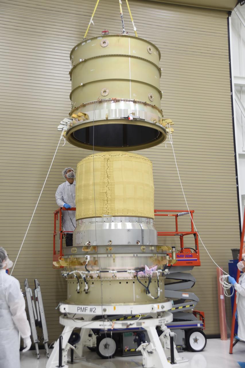 Technicians use a crane to mate the re-entry vehicle payload adapter canister for the Low-Earth Orbit Flight Test of an Inflatable Decelerator (LOFTID) with the payload adapter separation systems canister as part of launch preparations occurring inside Building 836 at Vandenberg Space Force Base (VSFB) in California on Sept. 8, 2022. LOFTID is the secondary payload on NASA and the National Oceanic and Atmospheric Administration’s (NOAA) Joint Polar Satellite System-2 (JPSS-2) satellite mission. JPSS-2 is the third satellite in the Joint Polar Satellite System series. It is scheduled to lift off from VSFB on Nov. 1 from Space Launch Complex-3. JPSS-2, which will be renamed NOAA-21 after reaching orbit, will join a constellation of JPSS satellites that orbit from the North to the South pole, circling Earth 14 times a day and providing a full view of the entire globe twice daily. 