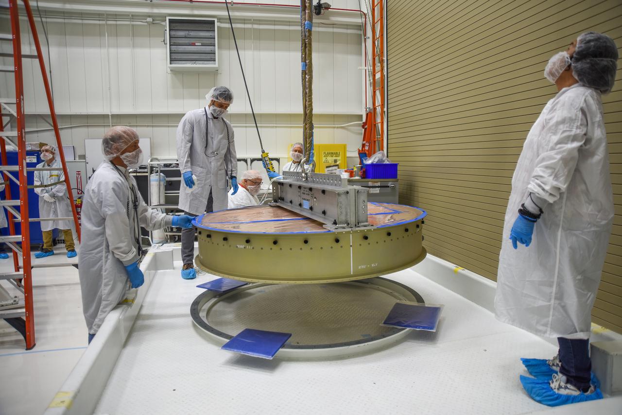 Technicians prepare the payload adapter separation systems canister to be secured onto NASA’s Low-Earth Orbit Flight Test of an Inflatable Decelerator (LOFTID) payload stack as part of launch preparations occurring inside Building 836 at Vandenberg Space Force Base (VSFB) in California on Sept. 9, 2022. LOFTID is the secondary payload on the National Oceanic and Atmospheric Administration’s (NOAA) Joint Polar Satellite System-2 (JPSS-2) satellite mission. JPSS-2 is the third satellite in the Joint Polar Satellite System series. It is scheduled to lift off from VSFB on Nov. 1 from Space Launch Complex-3. JPSS-2, which will be renamed NOAA-21 after reaching orbit, will join a constellation of JPSS satellites that orbit from the North to the South pole, circling Earth 14 times a day and providing a full view of the entire globe twice daily. LOFTID will demonstrate inflatable heat shield technology that could enable a variety of proposed NASA missions to destinations such as Mars, Venus, and Titan, as well as returning heavier payloads from low-Earth orbit. 