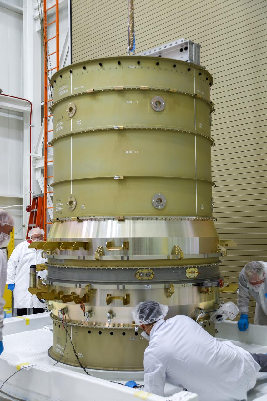 Technicians secure NASA’s Low-Earth Orbit Flight Test of an Inflatable Decelerator (LOFTID) stack onto a ground transport vehicle as part of launch preparations occurring inside Building 836 at Vandenberg Space Force Base (VSFB) in California on Sept. 9, 2022. LOFTID is the secondary payload on the National Oceanic and Atmospheric Administration’s (NOAA) Joint Polar Satellite System-2 (JPSS-2) satellite mission. JPSS-2 is the third satellite in the Joint Polar Satellite System series. It is scheduled to lift off from VSFB on Nov. 1 from Space Launch Complex-3. JPSS-2, which will be renamed NOAA-21 after reaching orbit, will join a constellation of JPSS satellites that orbit from the North to the South pole, circling Earth 14 times a day and providing a full view of the entire globe twice daily. LOFTID will demonstrate inflatable heat shield technology that could enable a variety of proposed NASA missions to destinations such as Mars, Venus, and Titan, as well as returning heavier payloads from low-Earth orbit.