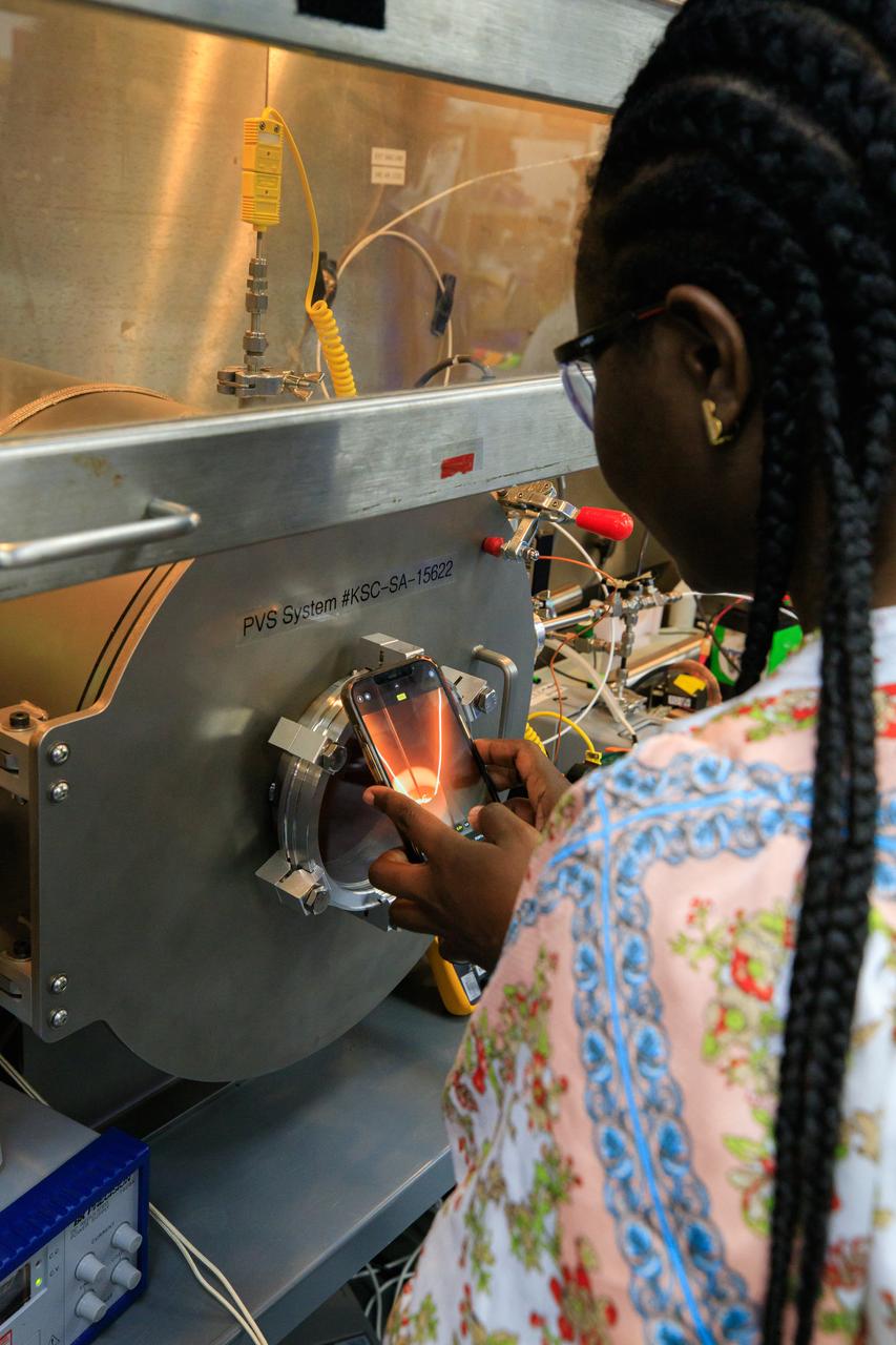 An engineer conducts testing of the Molten Regolith Electrolysis (MRE) inside a laboratory in the Neil Armstrong Operations and Checkout Building at NASA’s Kennedy Space Center in Florida on Sept. 13, 2022.  This is a high-temperature electrolytic process which aims to extract oxygen from the simulated lunar regolith. Extraction of oxygen on the lunar surface is critical to the agency’s Artemis program. Oxygen extracted from the Moon can be utilized for propellent to NASA’s lunar landers., breathable oxygen for astronauts, and a variety of other industrial and scientific applications for NASA’s future missions to the Moon. 
