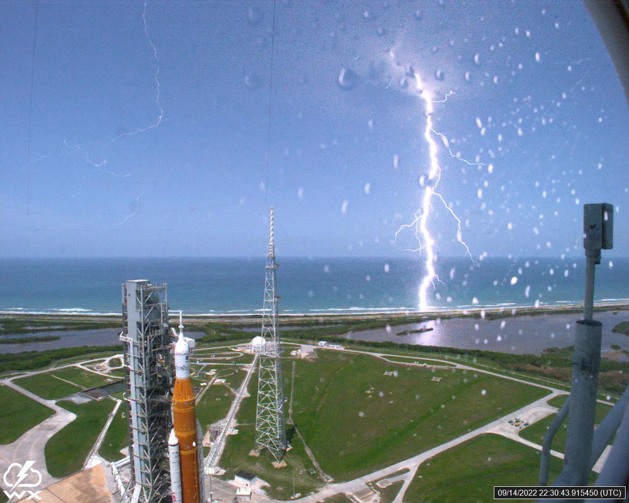 A lightning strike was recorded at Launch Complex 39B at NASA’s Kennedy Space Center in Florida on Sept. 14, 2022. NASA’s Space Launch System (SLS) and Orion spacecraft atop the mobile launcher are in view on the launch pad in preparation for the Artemis I mission. The lightning strike was recorded by cameras stationed at the pad and mobile launcher using a special filter called a “clear day frame,” which provides an overlay of the raw frame on a reference image. Artemis I will be the first integrated test of the SLS and Orion spacecraft. In later missions, NASA will land the first woman and the first woman of color on the surface of the Moon, paving the way for a long-term lunar presence and serving as a steppingstone on the way to Mars. 