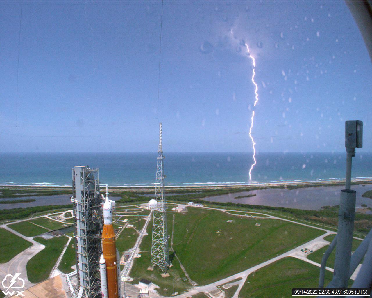 A lightning strike was recorded at Launch Complex 39B at NASA’s Kennedy Space Center in Florida on Sept. 14, 2022. NASA’s Space Launch System (SLS) and Orion spacecraft atop the mobile launcher are in view on the launch pad in preparation for the Artemis I mission. The lightning strike was recorded by cameras stationed at the pad and mobile launcher using a special filter called a “clear day frame,” which provides an overlay of the raw frame on a reference image. Artemis I will be the first integrated test of the SLS and Orion spacecraft. In later missions, NASA will land the first woman and the first woman of color on the surface of the Moon, paving the way for a long-term lunar presence and serving as a steppingstone on the way to Mars. 