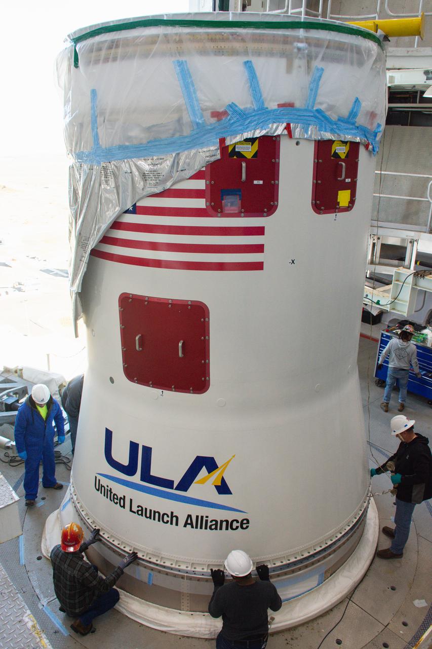 Technicians help secure the United Launch Alliance Atlas V interstage adapter and aft stub adapter to the Atlas V rocket inside the vertical integration facility at Space Launch Complex-3 at Vandenberg Space Force Base in California on Sept. 29, 2022. The rocket is being prepared to launch the National Oceanic and Atmospheric Administration’s (NOAA) Joint Polar Satellite System-2 (JPSS-2). JPSS-2 and NASA’s Low-Earth Orbit Flight Test of an Inflatable Decelerator (LOFTID) secondary payload. The launch is scheduled for Nov. 1 from SLC-3. JPSS-2, which will be renamed NOAA-21 after reaching orbit, will join a constellation of JPSS satellites that orbit from the North to the South pole, circling Earth 14 times a day and providing a full view of the entire globe twice daily. The NOAA/NASA Suomi National Polar-orbiting Partnership (Suomi NPP) satellite, and NOAA-20, previously known as JPSS-1, are both already in orbit. Each satellite carries at least four advanced instruments to measure weather and climate conditions on Earth. LOFTID is dedicated to the memory of Bernard Kutter. LOFTID will demonstrate inflatable heat shield technology that could enable a variety of proposed NASA missions to destinations such as Mars, Venus, and Titan, as well as returning heavier payloads from low-Earth orbit. 