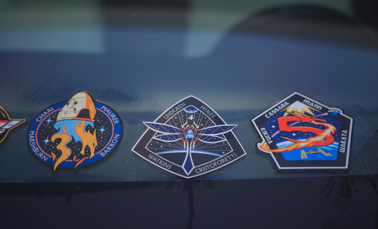 Seen here is a close-up view of stickers for NASA’s SpaceX Crew-3, Crew-4, and Crew-5 missions that were placed on one of the Tesla Model X cars that carry astronauts from the Neil A. Armstrong Operations and Checkout Building to Launch Complex 39A at the agency’s Kennedy Space Center in Florida. NASA’s SpaceX Crew-5 astronauts participated in a countdown dress rehearsal on Oct. 2, 2022, in preparation for the upcoming Crew-5 launch. SpaceX’s Crew Dragon Endurance spacecraft will carry NASA astronauts Nicole Aunapu Mann and Josh Cassada, Roscosmos cosmonaut Anna Kikina, and JAXA (Japan Aerospace Exploration Agency) astronaut Koichi Wakata to the International Space Station for a science expedition mission as part of the agency’s Commercial Crew Program. Liftoff of the SpaceX Falcon 9 rocket is targeted for noon EDT on Oct. 5, 2022, from Kennedy’s Launch Complex 39A.