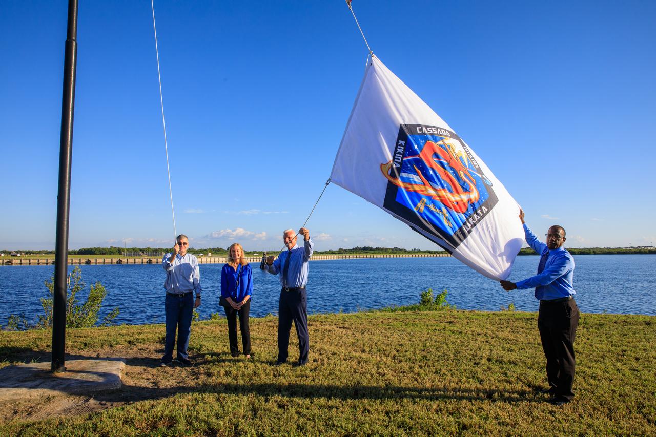 NASA Commercial Crew Program (CCP) employees Tyrell Hawkins (right) and Henry May (second from right) raise the Crew-5 flag near the countdown clock at the Press Site at NASA’s Kennedy Space Center in Florida on Oct. 3, 2022. Next to May is his wife, and to the left is CCP Manager Steve Stich. NASA’s SpaceX Crew-5 mission will carry NASA astronauts Josh Cassada and Nicole Aunapu Mann, Roscosmos cosmonaut Anna Kikina, and JAXA (Japan Aerospace Exploration Agency) to the International Space Station for a science expedition mission as part of the agency’s CCP. SpaceX’s Falcon 9 rocket and Crew Dragon Endurance spacecraft are scheduled to lift off from Kennedy’s Launch Complex 39A at noon EDT on Oct. 5, 2022.