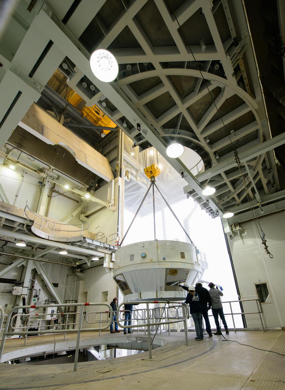 Inside the Vertical Integration Facility (VIF) at Vandenberg Space Force Base in California, technicians monitor the United Launch Alliance (ULA) Atlas V boattail as it’s lowered by crane onto the rocket’s Centaur upper stage on Oct. 4, 2022, for the National Oceanic and Atmospheric Administration’s (NOAA) and NASA’s Joint Polar Satellite System-2 (JPSS-2) mission. The boattail is the connecting piece of flight hardware that joins that Atlas V upper stage with the payload fairing – the protective casing surrounding the JPSS-2 satellite. Once the payload fairing arrives at the VIF, teams will lower it onto the boattail to complete the Atlas V stack. JPSS-2 is the third satellite in the Joint Polar Satellite System series and will scan the Earth as it orbits from the North to the South Pole, crossing the equator 14 times a day. Operating from 512 miles above Earth, JPSS-2 will capture data to improve weather forecasts, in turn helping scientists predict and prepare for extreme weather events and climate change. Launching as a secondary payload to JPSS-2 is NASA’s Low-Earth Orbit Flight Test of an Inflatable Decelerator (LOFTID), dedicated to the memory of Bernard Kutter. LOFTID is a technology demonstration of an inflatable heat shield that could one day help land humans on Mars. Liftoff is targeted for 2:25 a.m. Pacific time (5:25 a.m. Eastern time) on Nov. 1, 2022, from Vandenberg’s Space Launch Complex-3E.