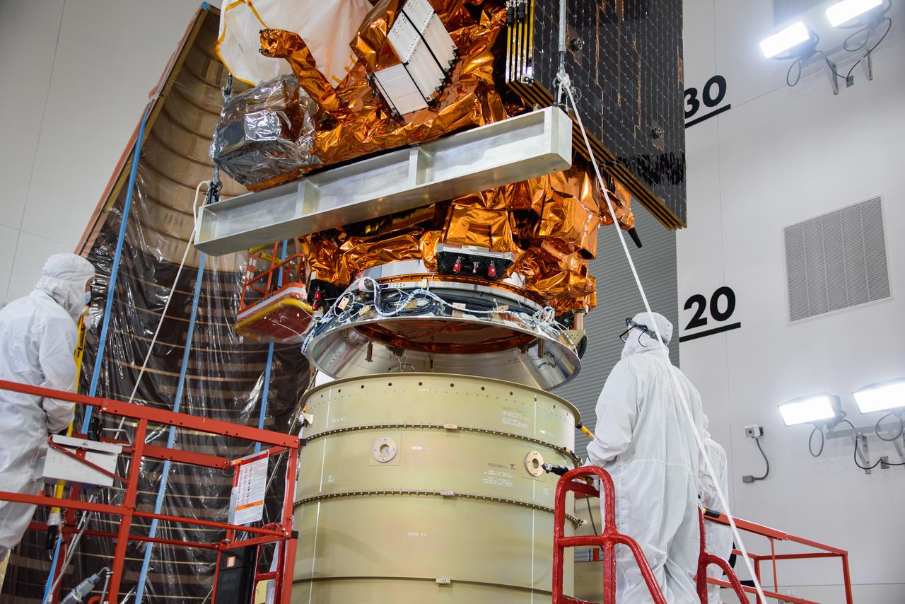 Technicians assist as a crane lowers the National Oceanic and Atmospheric Administration’s (NOAA) Joint Polar Satellite System-2 (JPSS-2) onto the Low-Earth Orbit Flight Test of an Inflatable Decelerator (LOFTID) payload inside the Astrotech Space Operations facility at Vandenberg Space Force Base (VSFB) in California on Oct. 5, 2022. JPSS-2 is the third satellite in the Joint Polar Satellite System series. It is scheduled to lift off from VSFB on Nov. 1 from Space Launch Complex-3. JPSS-2, which will be renamed NOAA-21 after reaching orbit, will join a constellation of JPSS satellites that orbit from the North to the South pole, circling Earth 14 times a day and providing a full view of the entire globe twice daily. The NOAA/NASA Suomi National Polar-orbiting Partnership (Suomi NPP) satellite, and NOAA-20, previously known as JPSS-1, are both already in orbit. Each satellite carries at least four advanced instruments to measure weather and climate conditions on Earth. LOFTID is a secondary payload on the mission. It is dedicated to the memory of Bernard Kutter. LOFTID will demonstrate inflatable heat shield technology that could enable a variety of proposed NASA missions to destinations such as Mars, Venus, and Titan, as well as returning heavier payloads from low-Earth orbit. 