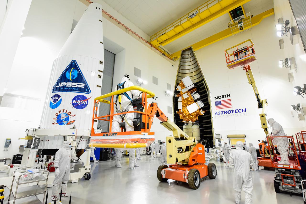 Technicians prepare to move the second half of the United Launch Alliance Atlas V payload fairing around the National Oceanic and Atmospheric Administration’s (NOAA) Joint Polar Satellite System-2 (JPSS-2), stacked atop NASA’s Low-Earth Orbit Flight Test of an Inflatable Decelerator (LOFTID) secondary payload inside the Astrotech Space Operations facility at Vandenberg Space Force Base (VSFB) in California on Oct. 12, 2022. JPSS-2 is the third satellite in the Joint Polar Satellite System series. It is scheduled to lift off from VSFB on Nov. 1 from Space Launch Complex-3. JPSS-2, which will be renamed NOAA-21 after reaching orbit, will join a constellation of JPSS satellites that orbit from the North to the South pole, circling Earth 14 times a day and providing a full view of the entire globe twice daily. The NOAA/NASA Suomi National Polar-orbiting Partnership (Suomi NPP) satellite, and NOAA-20, previously known as JPSS-1, are both already in orbit. Each satellite carries at least four advanced instruments to measure weather and climate conditions on Earth. LOFTID is dedicated to the memory of Bernard Kutter. LOFTID will demonstrate inflatable heat shield technology that could enable a variety of proposed NASA missions to destinations such as Mars, Venus, and Titan, as well as returning heavier payloads from low-Earth orbit. 
