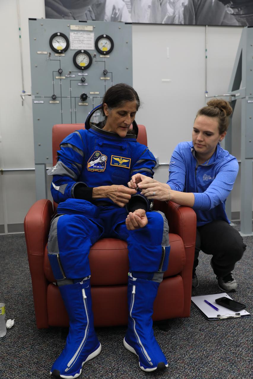 NASA astronaut Suni Williams, pilot for Boeing’s Crew Flight Test (CFT), checks her spacesuit during a crew validation test inside the Astronaut Crew Quarters at NASA’s Kennedy Space Center in Florida on Oct. 18, 2022. Williams, along with NASA astronauts Barry “Butch” Wilmore, CFT commander, and Mike Fincke, CFT backup spacecraft test pilot, with assistance from the Boeing team, successfully completed the validation test during which they suited up and tested out the pressurized crew module to ensure seat fit, suit functionality, cabin temperature, audio system, and day of launch operations. Boeing’s CFT is scheduled to launch in April 2023.