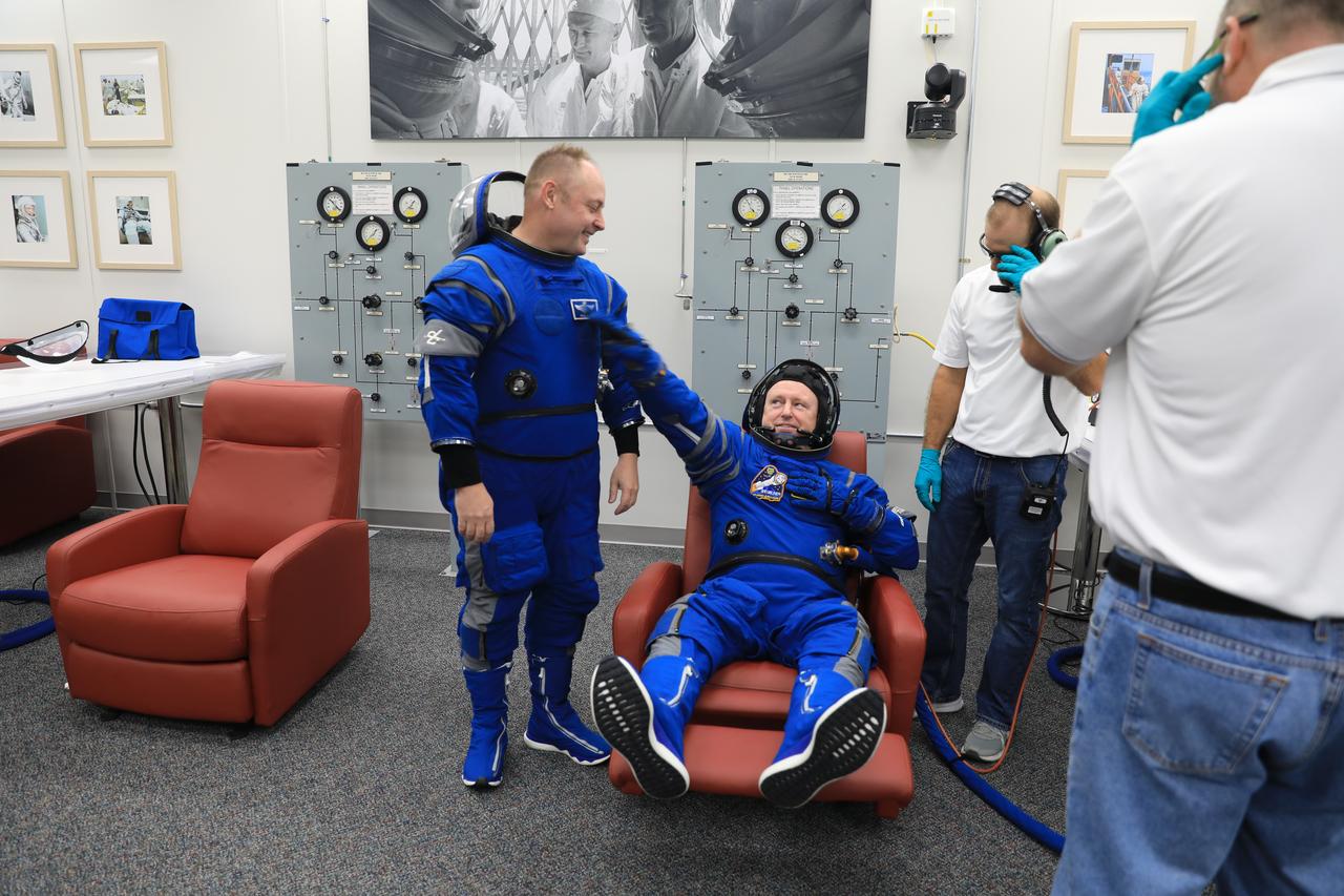 NASA astronaut Barry “Butch” Wilmore (right), Boeing Crew Flight Test (CFT) commander, and Mike Fincke, CFT backup spacecraft test pilot, check their spacesuits during a crew validation test inside the Astronaut Crew Quarters at NASA’s Kennedy Space Center in Florida on Oct. 18, 2022. Wilmore and Fincke, along with NASA astronaut Suni Williams, CFT pilot, with assistance from the Boeing team, successfully completed the validation test during which they suited up and tested out the pressurized crew module to ensure seat fit, suit functionality, cabin temperature, audio system, and day of launch operations. Boeing’s CFT is scheduled to launch in April 2023.