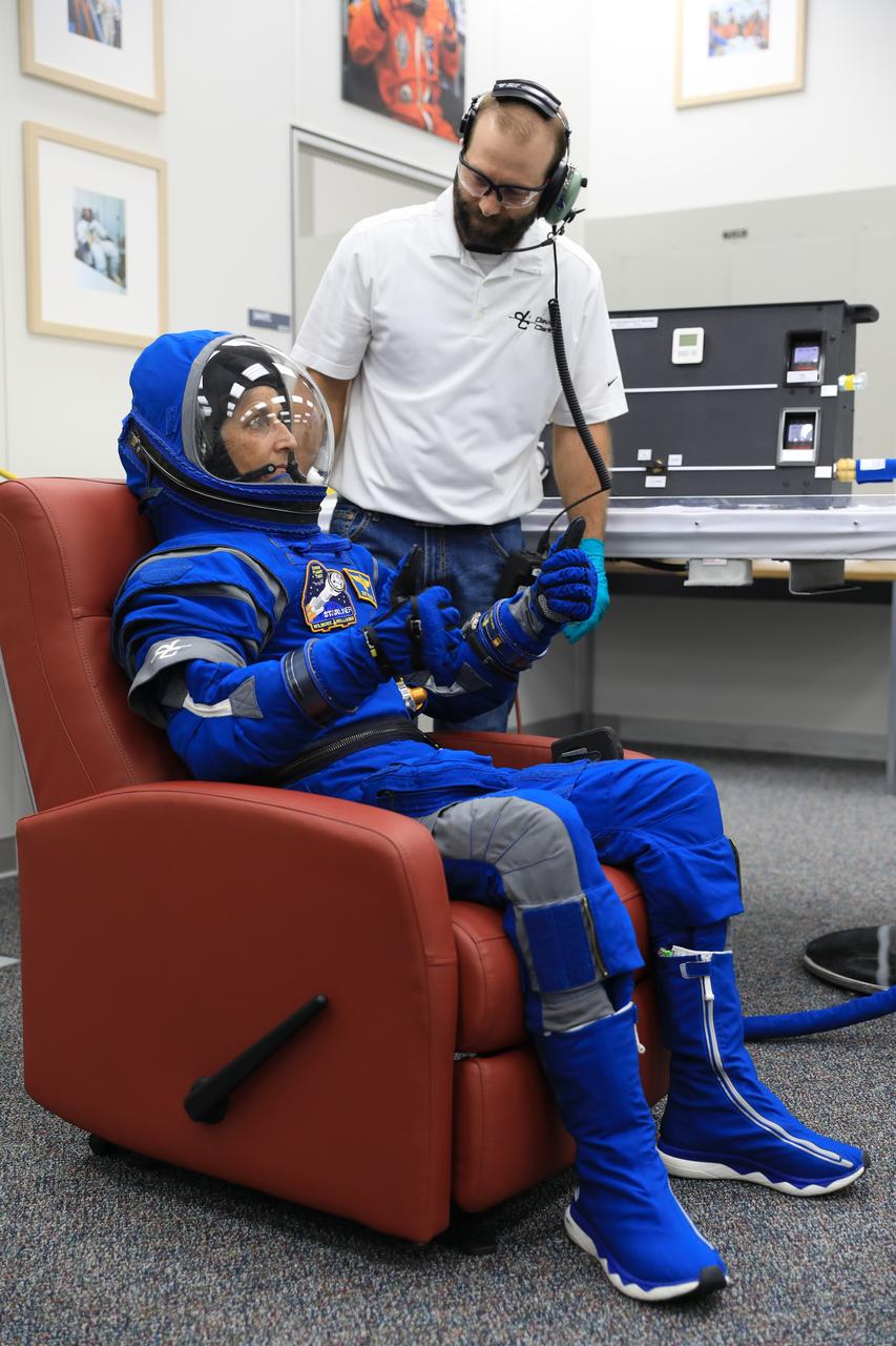 NASA astronaut Suni Williams, pilot for Boeing’s Crew Flight Test (CFT), checks her spacesuit and helmet during a crew validation test inside the Astronaut Crew Quarters at NASA’s Kennedy Space Center in Florida on Oct. 18, 2022. Williams, along with NASA astronauts Barry “Butch” Wilmore, CFT commander, and Mike Fincke, CFT backup spacecraft test pilot, with assistance from the Boeing team, successfully completed the validation test during which they suited up and tested out the pressurized crew module to ensure seat fit, suit functionality, cabin temperature, audio system, and day of launch operations. Boeing’s CFT is scheduled to launch in April 2023.