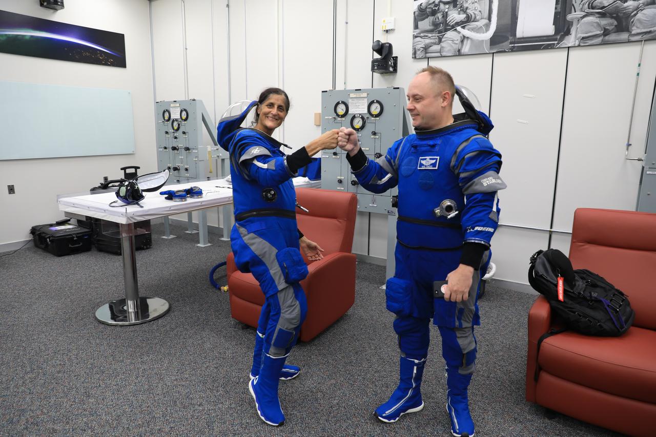 From left, NASA astronaut Suni Williams, Boeing Crew Flight Test (CFT) pilot, and Mike Fincke, CFT backup spacecraft test pilot, do a fist bump during a crew validation test inside the Astronaut Crew Quarters at NASA’s Kennedy Space Center in Florida on Oct. 18, 2022. Williams and Fincke, along with Barry “Butch” Wilmore, CFT commander, with assistance from the Boeing team, successfully completed the validation test during which they suited up and tested out the pressurized crew module to ensure seat fit, suit functionality, cabin temperature, audio system, and day of launch operations. Boeing’s CFT is scheduled to launch in April 2023.