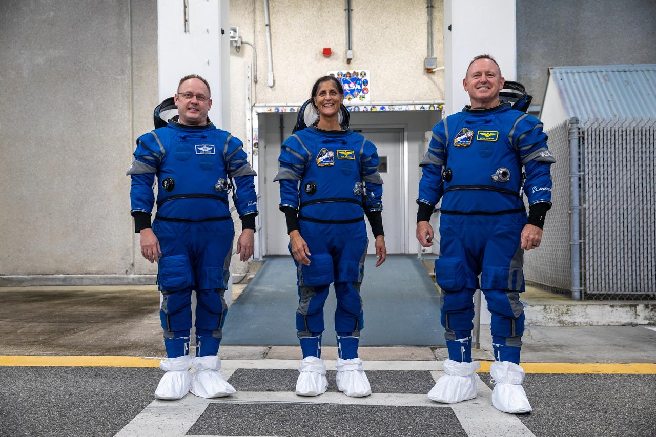 From left, NASA astronauts Mike Fincke, Suni Williams, and Barry “Butch” Wilmore, Boeing Crew Flight Test (CFT) backup spacecraft test pilot, pilot, and commander, respectively, exit the Astronaut Crew Quarters at NASA’s Kennedy Space Center in Florida during a crew validation test on Oct. 18, 2022. The astronauts, with assistance from the Boeing team, successfully completed the validation test during which they suited up and tested out the pressurized crew module to ensure seat fit, suit functionality, cabin temperature, audio system, and day of launch operations. Boeing’s CFT is scheduled to launch in April 2023. 