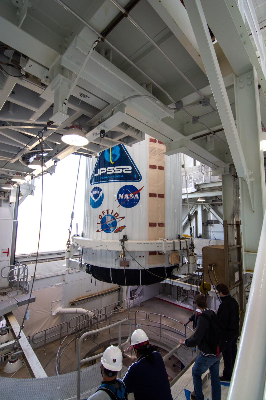 The United Launch Alliance Atlas V payload fairing containing the National Oceanic and Atmospheric Administration’s (NOAA) Joint Polar Satellite System-2 (JPSS-2) is lowered by crane inside the vertical integration facility at Space Launch Complex 3 at Vandenberg Space Force Base (VSFB) in California on Oct. 18, 2022. The fairing will be attached to the Atlas V rocket. Inside the fairing, JPSS-2 is stacked atop NASA’s Low-Earth Orbit Flight Test of an Inflatable Decelerator (LOFTID) secondary payload. JPSS-2 is the third satellite in the Joint Polar Satellite System series. It is scheduled to lift off from VSFB on Nov. 1 from SLC-3. JPSS-2, which will be renamed NOAA-21 after reaching orbit, will join a constellation of JPSS satellites that orbit from the North to the South pole, circling Earth 14 times a day and providing a full view of the entire globe twice daily. The NOAA/NASA Suomi National Polar-orbiting Partnership (Suomi NPP) satellite, and NOAA-20, previously known as JPSS-1, are both already in orbit. Each satellite carries at least four advanced instruments to measure weather and climate conditions on Earth. LOFTID is dedicated to the memory of Bernard Kutter. LOFTID will demonstrate inflatable heat shield technology that could enable a variety of proposed NASA missions to destinations such as Mars, Venus, and Titan, as well as returning heavier payloads from low-Earth orbit. 