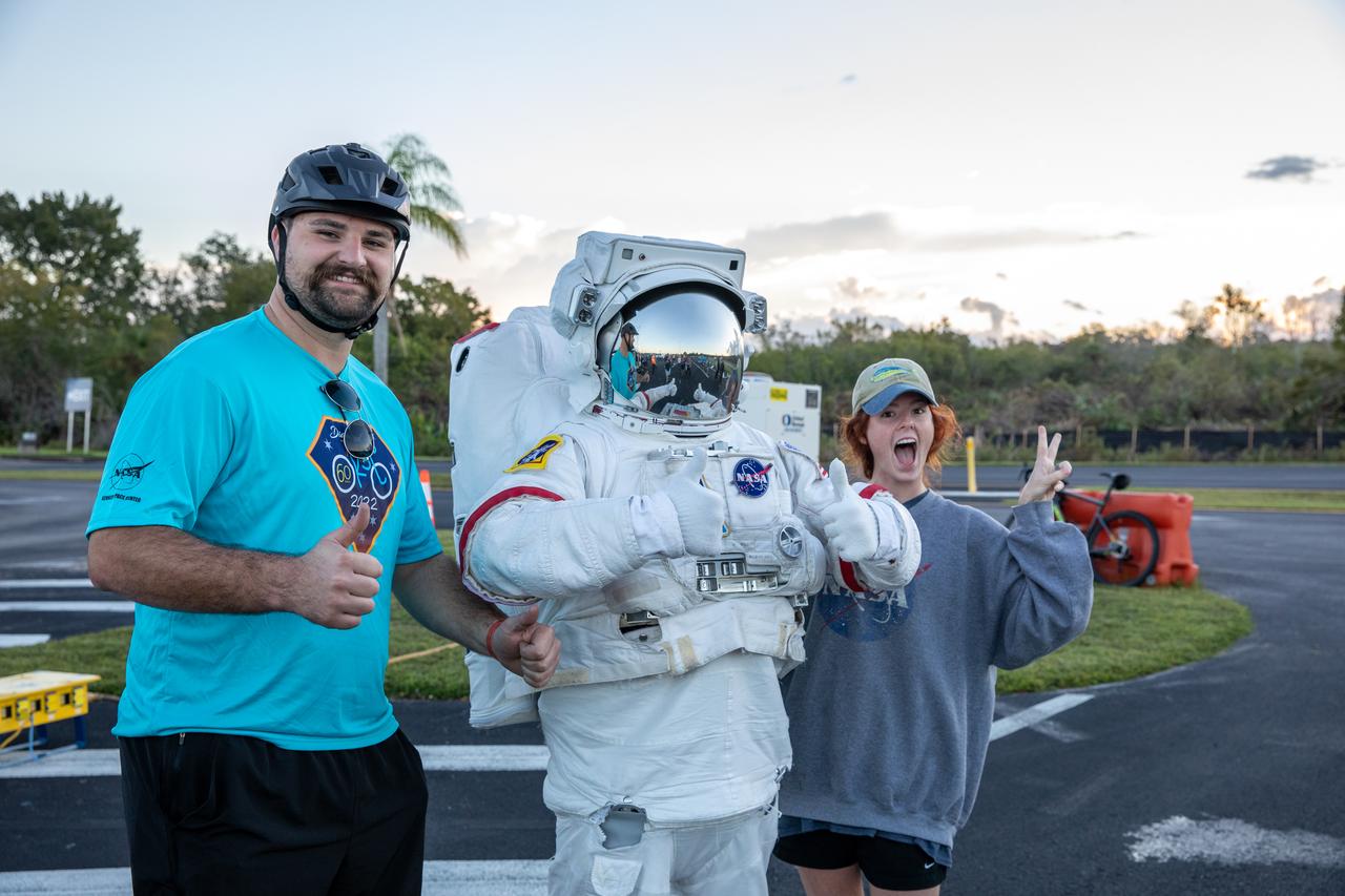 Participants in the Diamond Tour de KSC pause for a photo with the Spaceperson at NASA’s Kennedy Space Center Visitor Complex before beginning their bicycle routes at Kennedy Space Center in Florida on Oct. 22, 2022. This unique event, held for the first time since 2019, was part of the Safety organization’s Fall Into Safety and Health event, and named “diamond” to honor the center’s 60th anniversary. Cyclists covered three different routes and rode by historic landmarks, completing a total of about 37 miles. 
