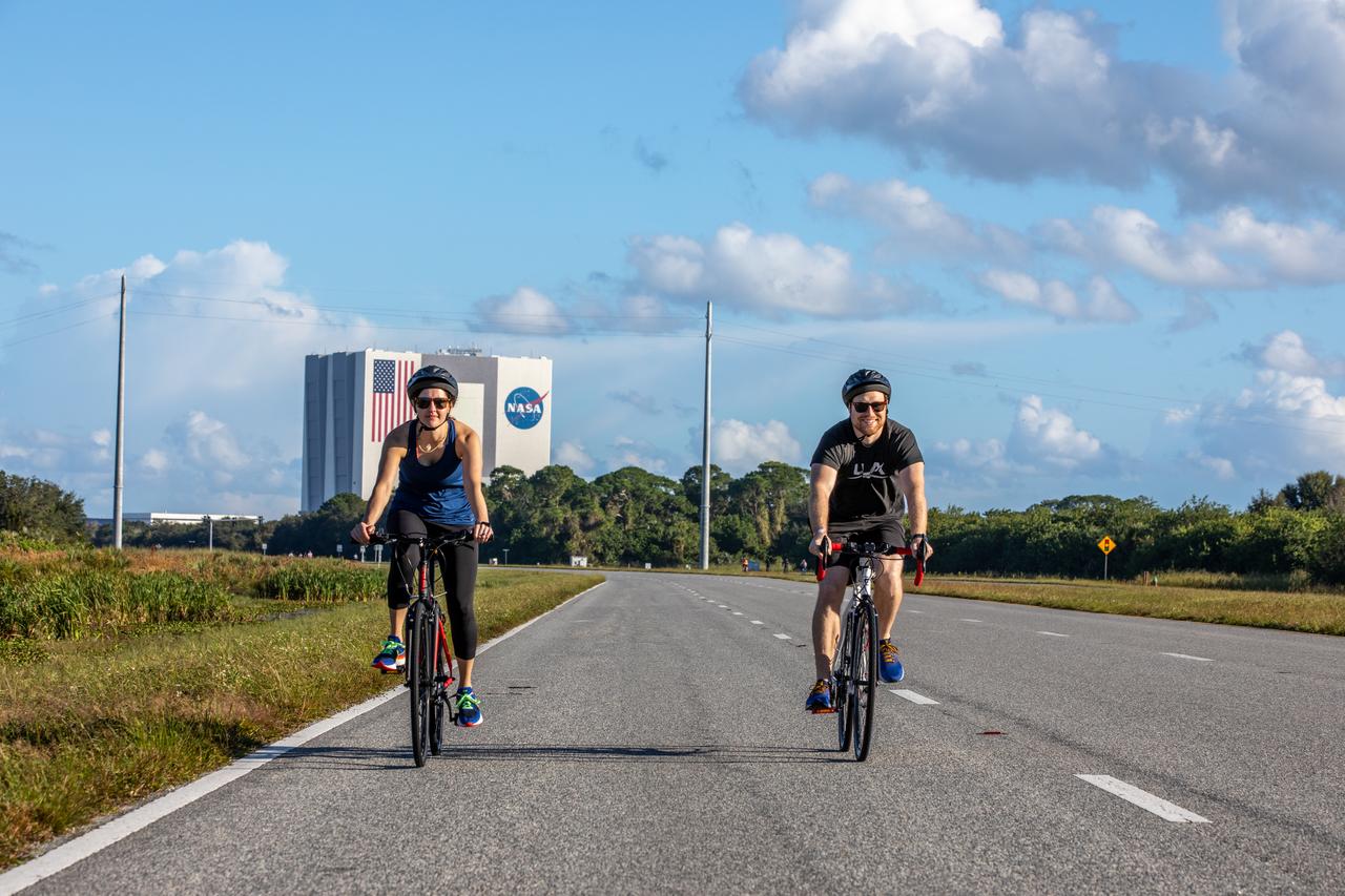 Two cyclists participate in the Diamond Tour de KSC at NASA’s Kennedy Space Center in Florida on Oct. 22, 2022. In the background is the iconic Vehicle Assembly Building. This unique event, held for the first time since 2019, was part of the Safety organization’s Fall Into Safety and Health event, and named “diamond” to honor the center’s 60th anniversary. Cyclists covered three different routes and rode by historic landmarks, completing a total of about 37 miles. 