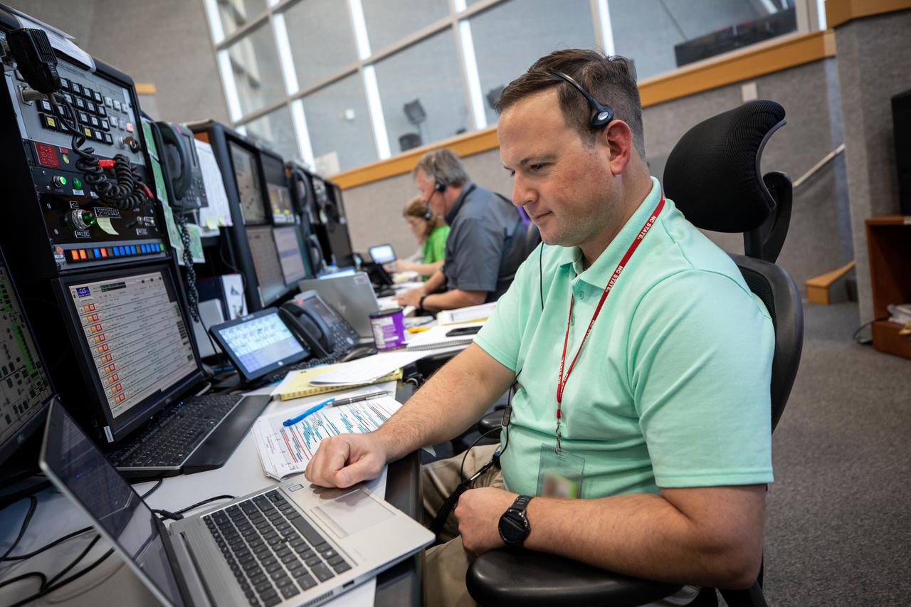 Wes Mosedale, technical assistant to the Artemis I launch director, monitors operations from his position in Firing Room 1 as Artemis teams conduct a launch simulation for the Artemis I mission inside the Rocco A. Petrone Launch Control Center at NASA’s Kennedy Space Center in Florida on Oct. 27, 2022. Artemis I will be the first integrated test of NASA’s Space Launch System (SLS) rocket and Orion spacecraft. The primary goal of Artemis I is to thoroughly test the integrated systems before crewed missions by launching Orion atop the SLS rocket, operating the spacecraft in a deep space environment, testing Orion’s heat shield, and recovering the crew module after reentry, descent, and splashdown. During the flight, Orion will launch atop the most powerful rocket in the world and fly farther than any human-rated spacecraft has ever flown, paving the way for human deep space exploration and demonstrating our commitment and capability to extend human presence to the Moon and beyond. 