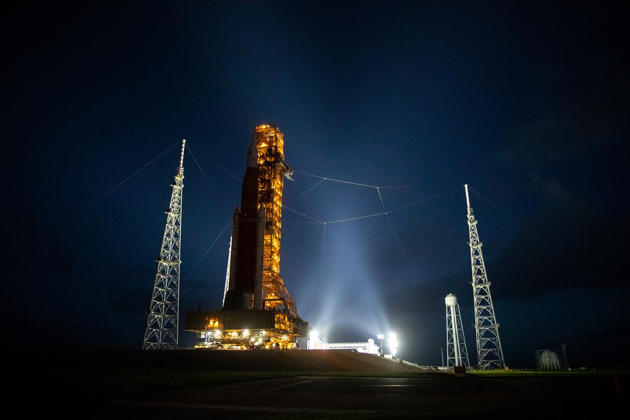 NASA’s Space Launch System (SLS) rocket and Orion spacecraft, standing atop the mobile launcher, arrive at Launch Pad 39B at the agency’s Kennedy Space Center in Florida on Nov. 4, 2022, ahead of the uncrewed Artemis I launch. Artemis I will be the first integrated test of NASA’s SLS rocket and Orion spacecraft and is scheduled to launch Monday, Nov. 14. The primary goal of Artemis I is to thoroughly test the integrated systems before crewed missions by launching Orion atop the SLS rocket, operating the spacecraft in a deep space environment, testing Orion’s heat shield, and recovering the crew module after reentry, descent, and splashdown. During the flight, Orion will launch atop the most powerful rocket in the world and fly farther than any human-rated spacecraft has ever flown, paving the way for human deep space exploration and demonstrating our commitment and capability to extend human presence to the Moon and beyond.