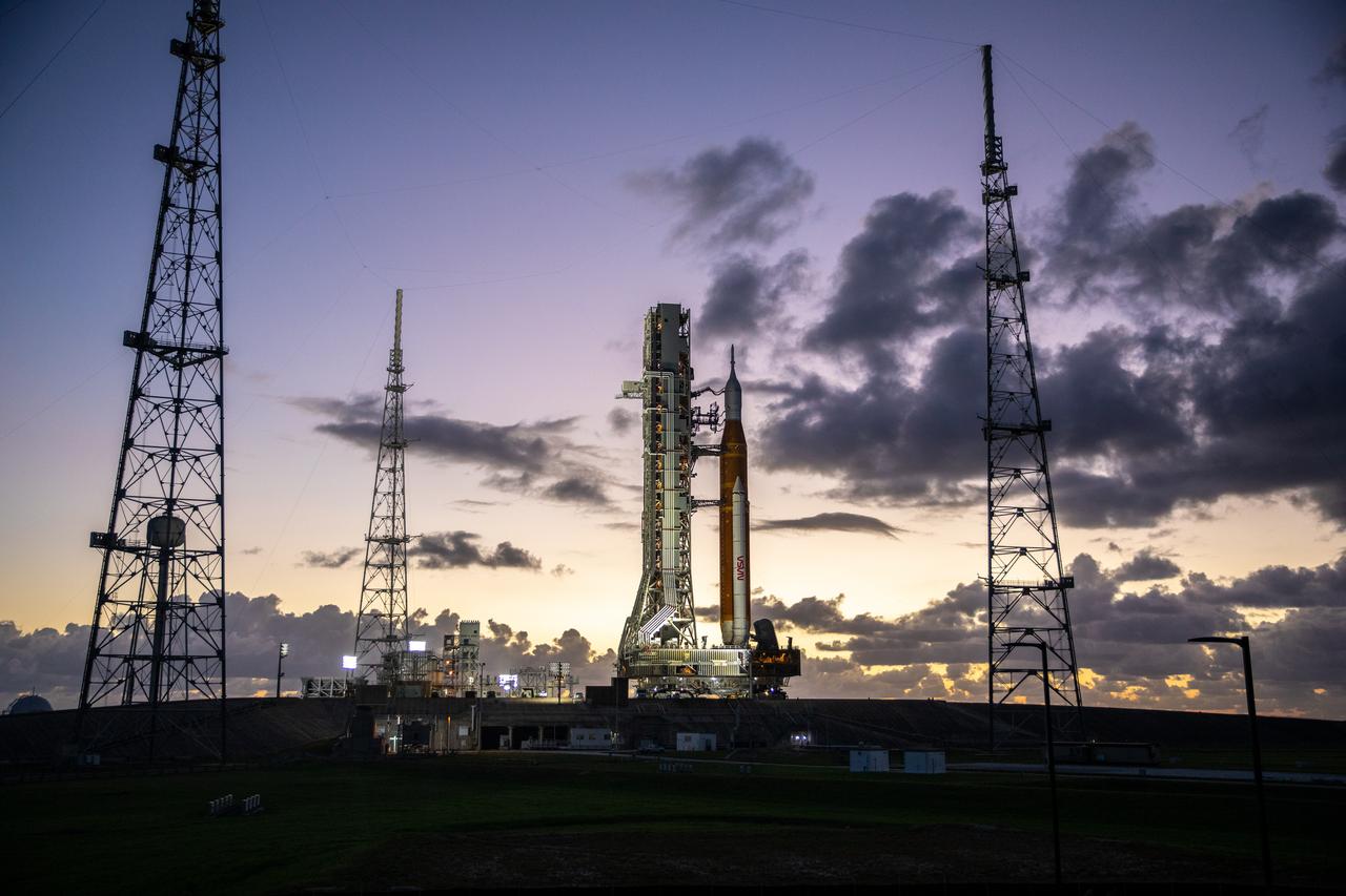 NASA’s Space Launch System (SLS) rocket and Orion spacecraft, standing atop the mobile launcher, arrive at Launch Pad 39B at the agency’s Kennedy Space Center in Florida on Nov. 4, 2022, ahead of the uncrewed Artemis I launch. Artemis I will be the first integrated test of NASA’s SLS rocket and Orion spacecraft and is scheduled to launch Monday, Nov. 14. The primary goal of Artemis I is to thoroughly test the integrated systems before crewed missions by launching Orion atop the SLS rocket, operating the spacecraft in a deep space environment, testing Orion’s heat shield, and recovering the crew module after reentry, descent, and splashdown. During the flight, Orion will launch atop the most powerful rocket in the world and fly farther than any human-rated spacecraft has ever flown, paving the way for human deep space exploration and demonstrating our commitment and capability to extend human presence to the Moon and beyond.