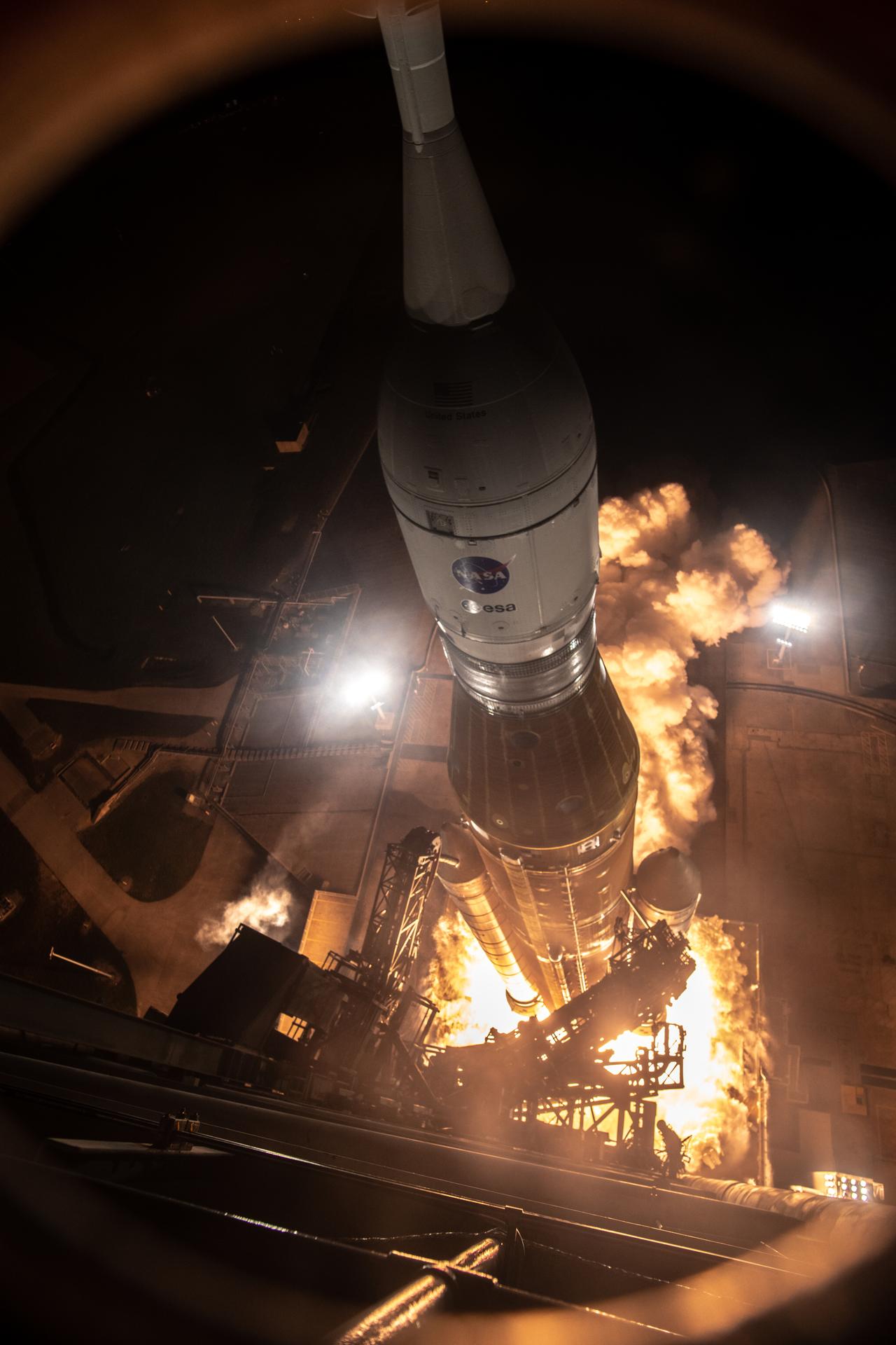 The SLS rocket launches into the dark sky