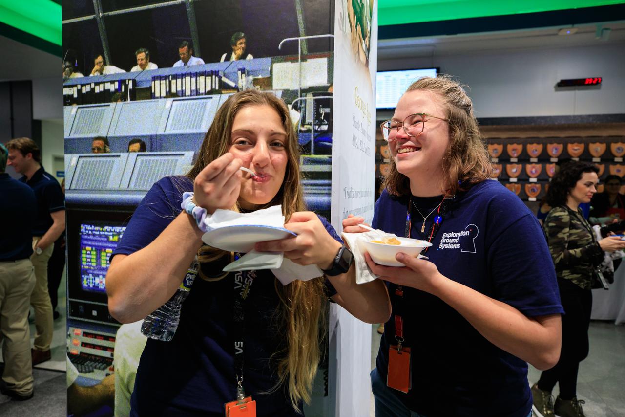 Artemis I launch team members celebrate the successful launch of NASA’s Space Launch System and Orion spacecraft on Nov. 16, 2022, with the traditional meal of beans and cornbread inside Firing Room 1 of the Launch Control Center at Kennedy Space Center in Florida. Liftoff was at 1:47 a.m. EST. The first in a series of increasingly complex missions, Artemis I will provide a foundation for human deep space exploration and demonstrate our commitment and capability to extend human presence to the Moon and beyond. The primary goal of Artemis I is to thoroughly test the integrated systems before crewed missions by operating the spacecraft in a deep space environment, testing Orion’s heat shield, and recovering the crew module after reentry, descent, and splashdown.