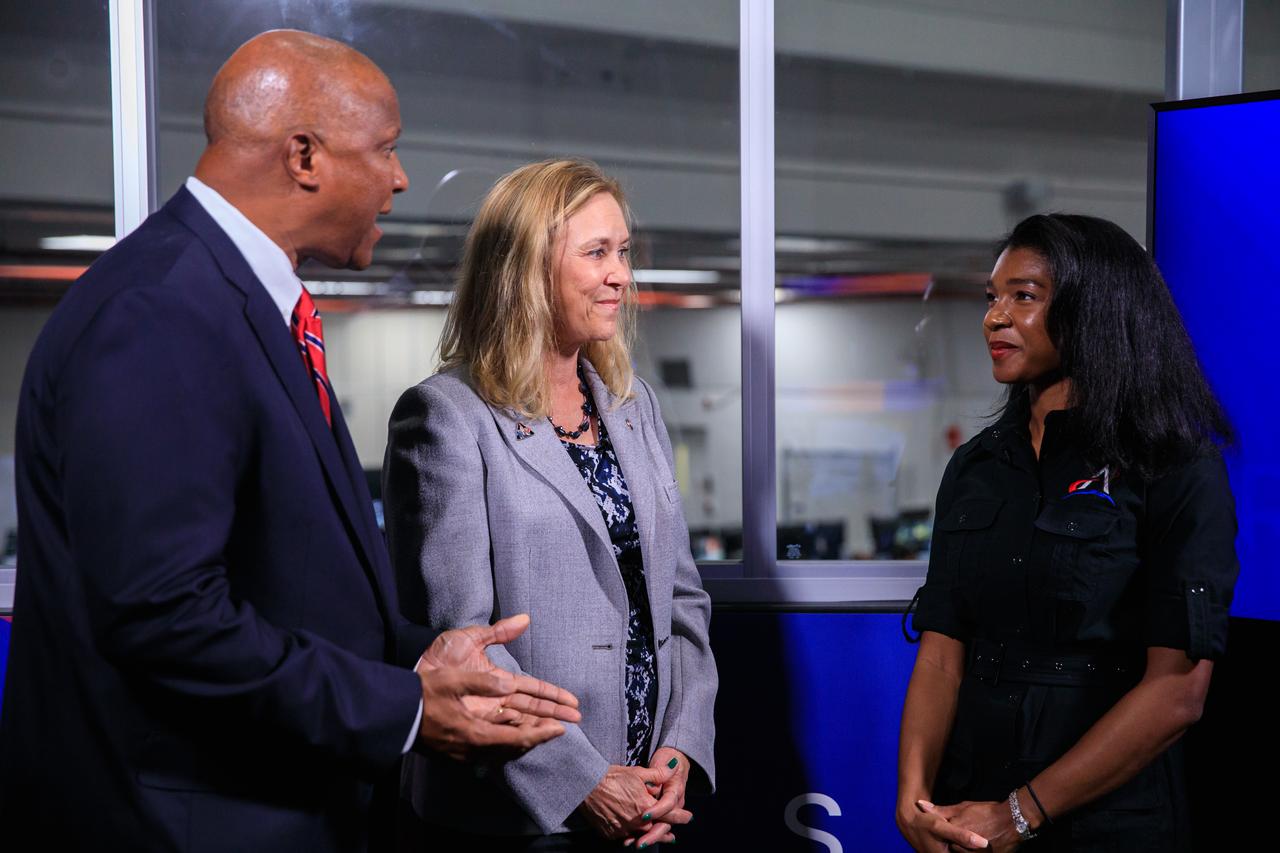 Jasmine Hopkins, at right, NASA Communications, speaks with Kelvin Manning, at left, deputy director, and Janet Petro, director of Kennedy Space Center, during Artemis I launch countdown activities inside Firing Room 1 of the Launch Control Center at NASA’s Kennedy Space Center in Florida on Nov. 16, 2022. Liftoff of the agency’s Space Launch System and Orion spacecraft from Launch Complex 39B was at 1:47 a.m. EST. The first in a series of increasingly complex missions, Artemis I will provide a foundation for human deep space exploration and demonstrate our commitment and capability to extend human presence to the Moon and beyond. The primary goal of Artemis I is to thoroughly test the integrated systems before crewed missions by operating the spacecraft in a deep space environment, testing Orion’s heat shield, and recovering the crew module after reentry, descent, and splashdown.