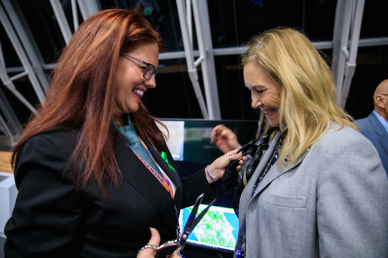 Artemis I Launch Director Charlie Blackwell-Thompson, at left, performs the traditional cutting of the tie for Kennedy Space Center Director Janet Petro after the successful liftoff of NASA’s Space Launch System and Orion spacecraft from Kennedy’s Launch Complex 39B on Nov. 16, 2022. Liftoff was at 1:47 a.m. EST. The first in a series of increasingly complex missions, Artemis I will provide a foundation for human deep space exploration and demonstrate our commitment and capability to extend human presence to the Moon and beyond. The primary goal of Artemis I is to thoroughly test the integrated systems before crewed missions by operating the spacecraft in a deep space environment, testing Orion’s heat shield, and recovering the crew module after reentry, descent, and splashdown.