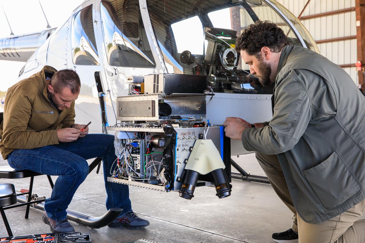 Two Intuitive Machines employees ready navigation pod sensors for the company’s Nova-C lunar lander in preparation for testing at NASA’s Kennedy Space Center in Florida on Nov. 18, 2022. The test involved flying the sensors over a simulated lunar surface at the Launch and Landing Facility on a private helicopter. Intuitive Machines is scheduled to launch two missions to the Moon in 2023 – one of which will carry NASA’s Mass Spectrometer observing lunar operations (MSolo) instrument that will help analyze the chemical makeup of landing sites on the Moon, as well as study water on the lunar surface. Through NASA’s Commercial Lunar Payload Services initiative, the agency selected Intuitive Machines to deliver science and technology demonstration payloads to the Moon, contributing to NASA’s goal of establishing a sustainable human presence on the lunar surface.