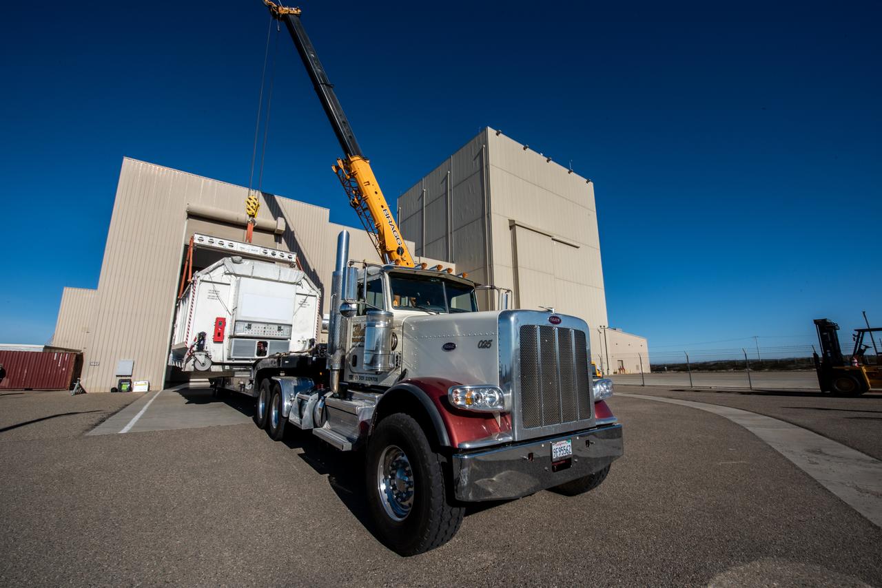 A container, with the Surface Water and Ocean Topography (SWOT) spacecraft inside, is moved to a trailer at the Astrotech facility at Vandenberg Space Force Base in California on Nov. 19, 2022. The satellite will be transported to the SpaceX facility at Vandenberg. SWOT is the first mission that will observe nearly all water on Earth’s surface, measuring the height of water in the planet’s lakes, rivers, reservoirs, and the ocean. It is set to launch aboard a SpaceX Falcon 9 rocket in December from Vandenberg’s Space Launch Center-4 East. NASA’s Launch Services Program, based at the agency’s Kennedy Space Center in Florida, is managing the launch service.
