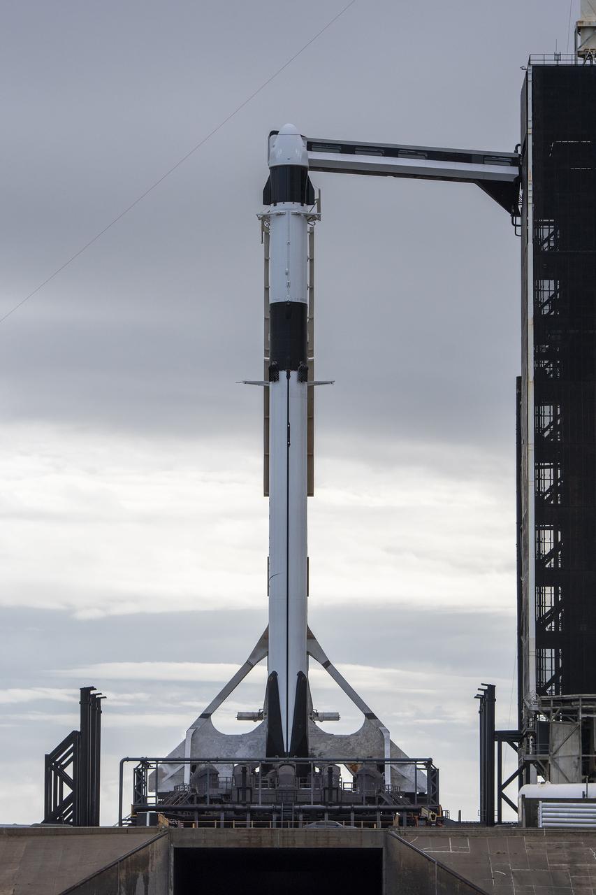 A SpaceX Falcon 9 rocket, with the company’s Dragon cargo spacecraft atop, is raised to a vertical position at NASA Kennedy Space Center’s Launch Complex 39A on Nov. 21, 2022, in preparation for the 26th commercial resupply services launch to the International Space Station. The mission will deliver new science investigations, supplies, and equipment to the crew aboard the space station, including the next pair of ISS Roll Out Solar Arrays (iROSAs). Liftoff is scheduled for 3:54 p.m. EST on Monday, Nov. 22, from Kennedy’s Launch Complex 39A.