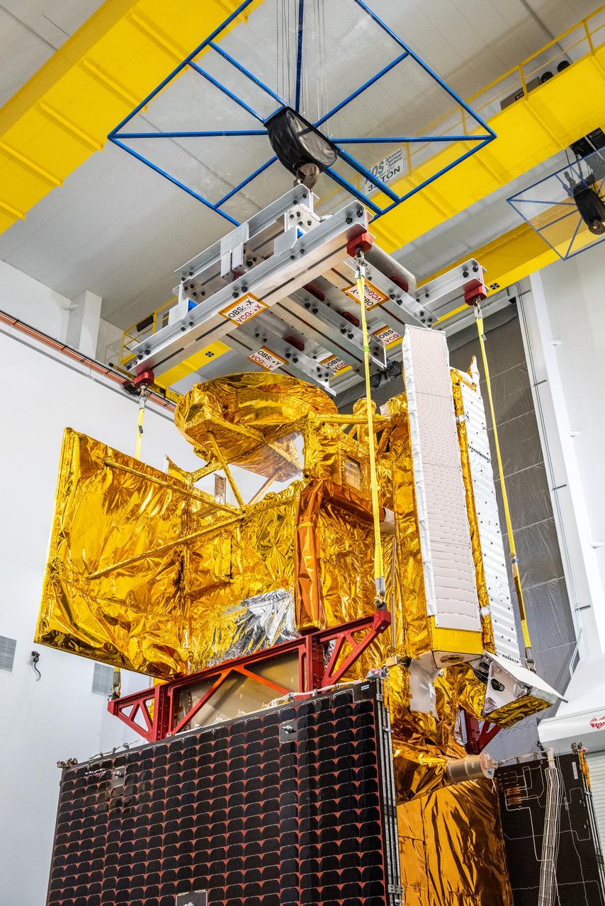 Inside the SpaceX facility at Vandenberg Space Force Base in California, a crane is used to lift the Surface Water and Ocean Topography (SWOT) satellite for mating to the payload adapter on Dec. 5, 2022. A collaboration between NASA and the French space agency Centre National d’Études Spatiales (CNES), with contributions from the Canadian Space Agency and the UK Space Agency, SWOT will be the first satellite to survey nearly all water on Earth’s surface. SWOT is scheduled to lift off aboard the SpaceX Falcon 9 rocket from Vandenberg on Dec. 15, 2022, at 3:46 a.m. PST. 