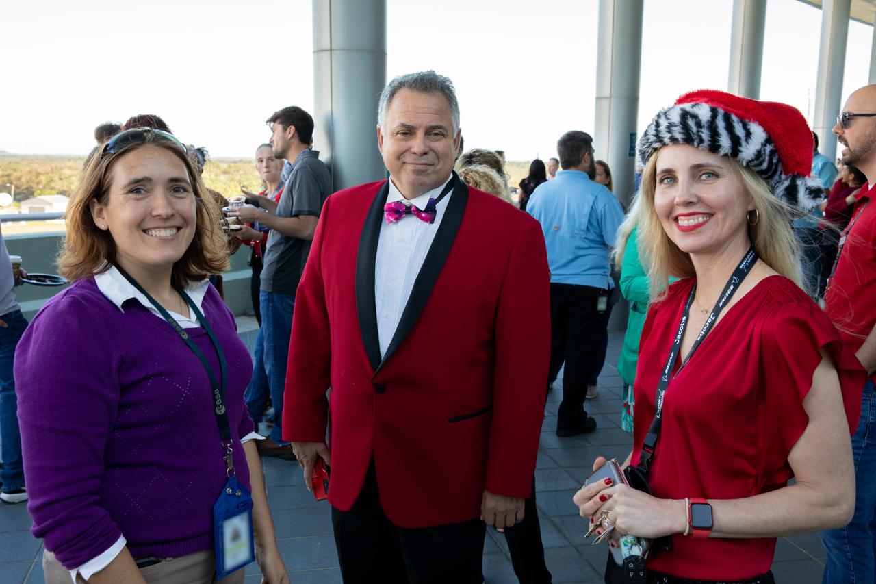 Kennedy Space Center employees attend the 2022 Center Director’s Holiday Coffee on Dec. 7, 2022, at NASA’s Kennedy Space Center in Florida. From left are Rebecca Mazzone, Richard Johanboeke, and Bethanne Hull. The annual holiday event is an opportunity for Kennedy employees and NASA retirees to exchange holiday greetings with center leaders and fellow support staff.