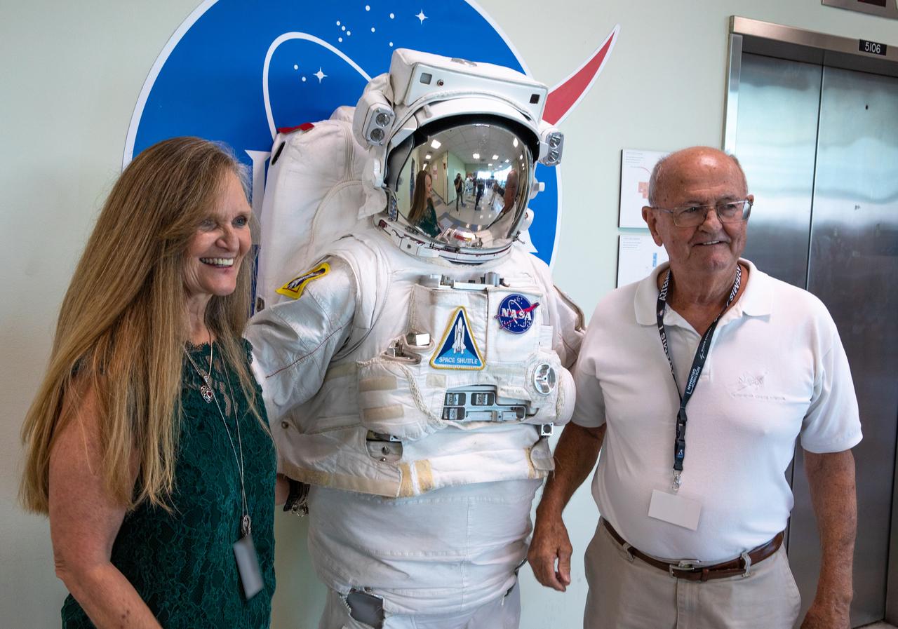 Two NASA retirees pose with Kennedy Space Center Visitor Complex’s Space Person, at the 2022 Center Director’s Holiday Coffee on Dec. 7, 2022, at NASA’s Kennedy Space Center in Florida. The annual holiday event is an opportunity for Kennedy employees and NASA retirees to exchange holiday greetings with center leaders and fellow support staff.