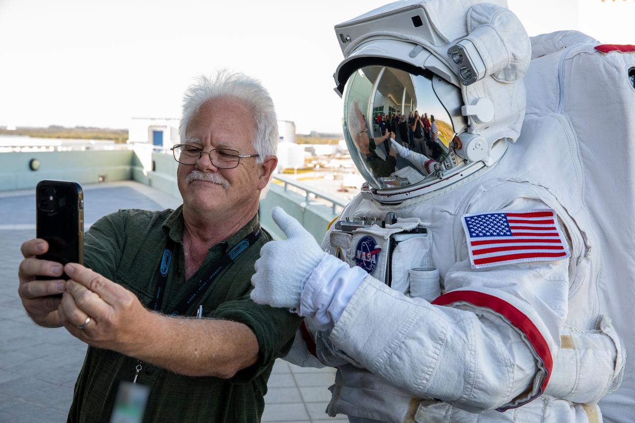 Kennedy Space Center employee Dean Pettit takes a selfie with Kennedy Space Center Visitor Complex’s Space Person, at the 2022 Center Director’s Holiday Coffee on Dec. 7, 2022, at NASA’s Kennedy Space Center in Florida. The annual holiday event is an opportunity for Kennedy employees and NASA retirees to exchange holiday greetings with center leaders and fellow support staff.