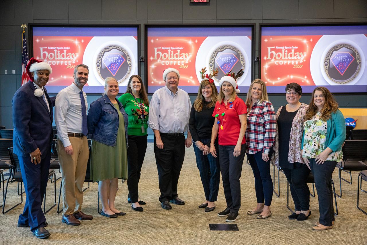 Kennedy Space Center Director Janet Petro, fourth from right, poses with other center leaders and support staff during the 2022 Center Director’s Holiday Coffee on Dec. 7, 2022, at NASA’s Kennedy Space Center in Florida. From left are Deputy Director Kelvin Manning; Kennedy Space Center employees Michael Haddad, Maggi Dutczak, and Cindy Rymer; Associate Director Technical Burt Summerfield; Associate Director Operations Jennifer Kunz; Petro; Kennedy employees Heidi Culp, Amber Chieffe, and Amanda Hayes. The annual holiday event is an opportunity for Kennedy employees and NASA retirees to exchange holiday greetings with center leaders and fellow support staff.