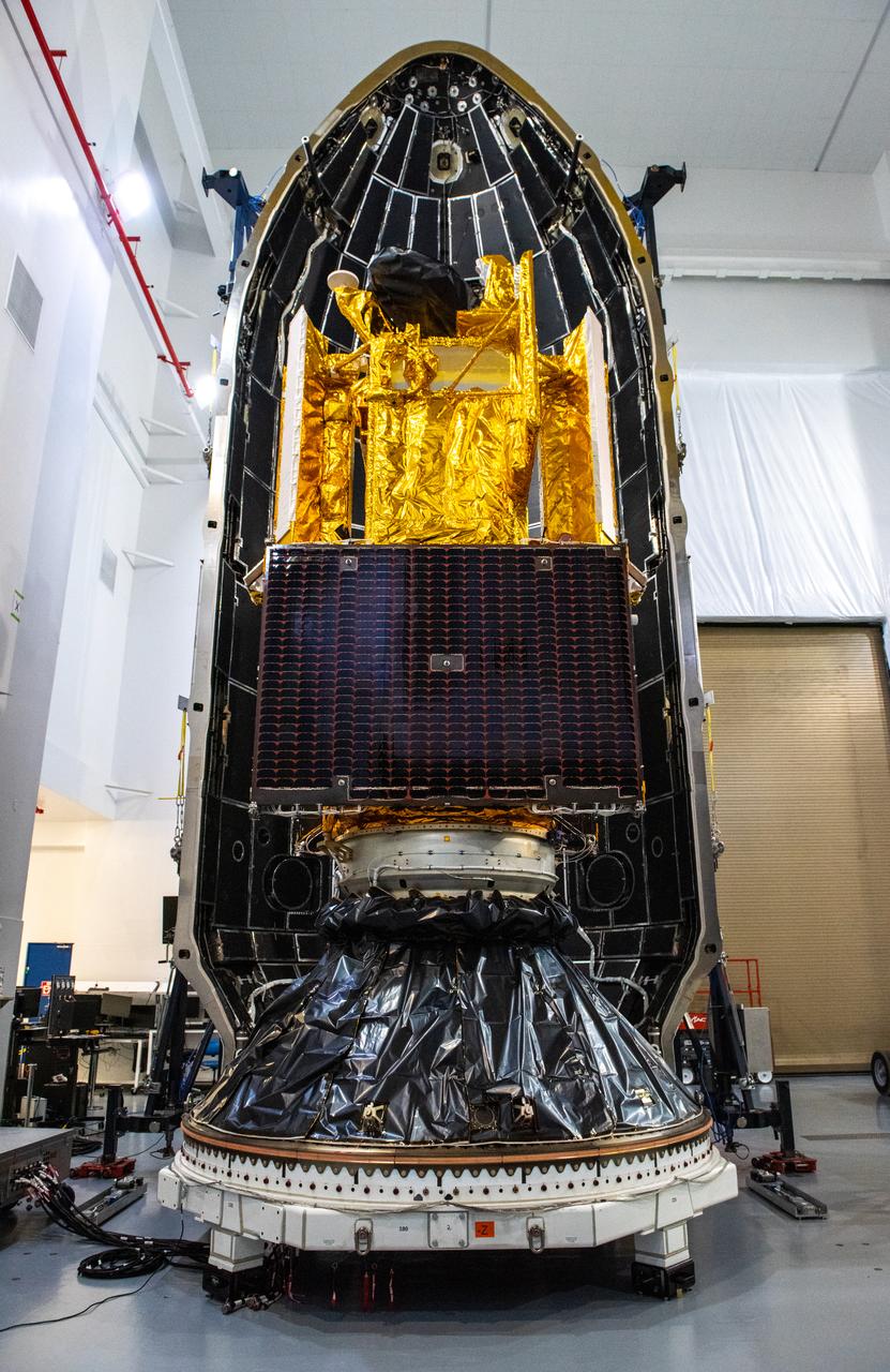 Inside the SpaceX facility at Vandenberg Space Force Base in California, the first half of the SpaceX Falcon 9 payload fairing is moved around the Surface Water and Ocean Topography (SWOT) satellite on Dec. 8, 2022. A collaboration between NASA and the French space agency Centre National d’Études Spatiales (CNES), with contributions from the Canadian Space Agency and the UK Space Agency, SWOT will be the first satellite to survey nearly all water on Earth’s surface. SWOT is scheduled to lift off aboard the SpaceX Falcon 9 rocket from Vandenberg on Dec. 15, 2022, at 3:46 a.m. PST. 